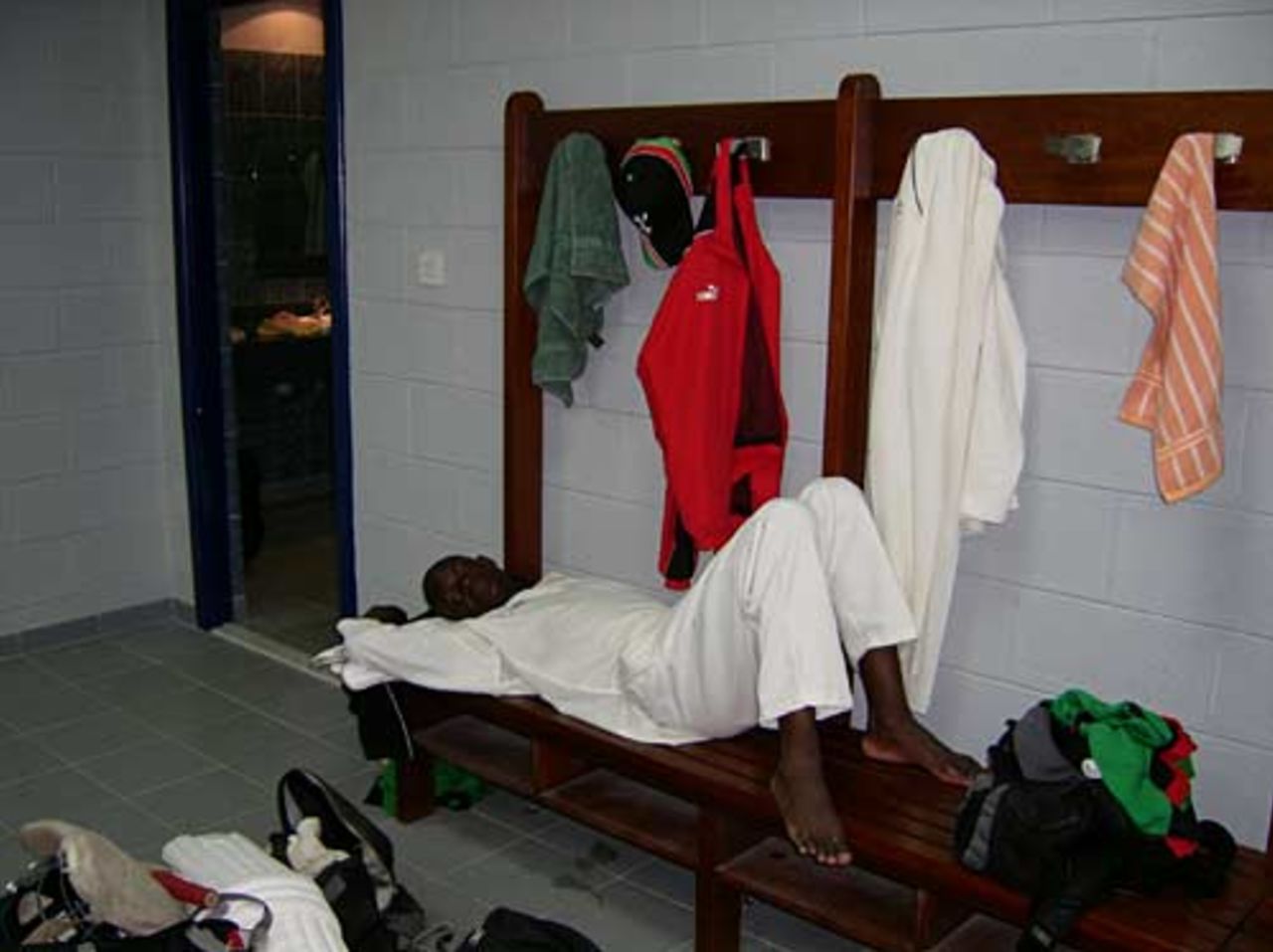 Lameck Onyango lies down after pulling a muscle during the match against Scotland at Abu Dhabi, November 2004