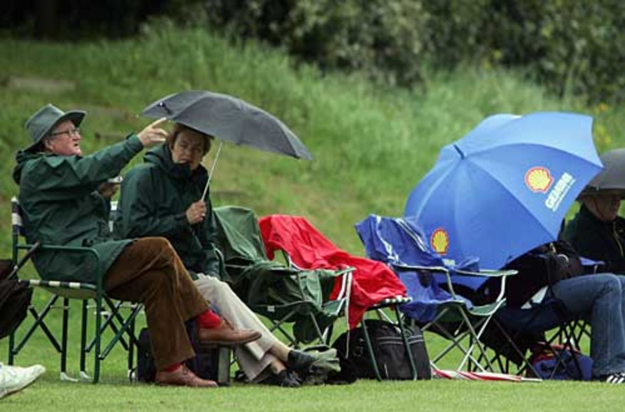 Spectators take shelter during the 1st round of the C&G Trophy, Berkshire v Gloucestershire, Reading Cricket Club, May 2