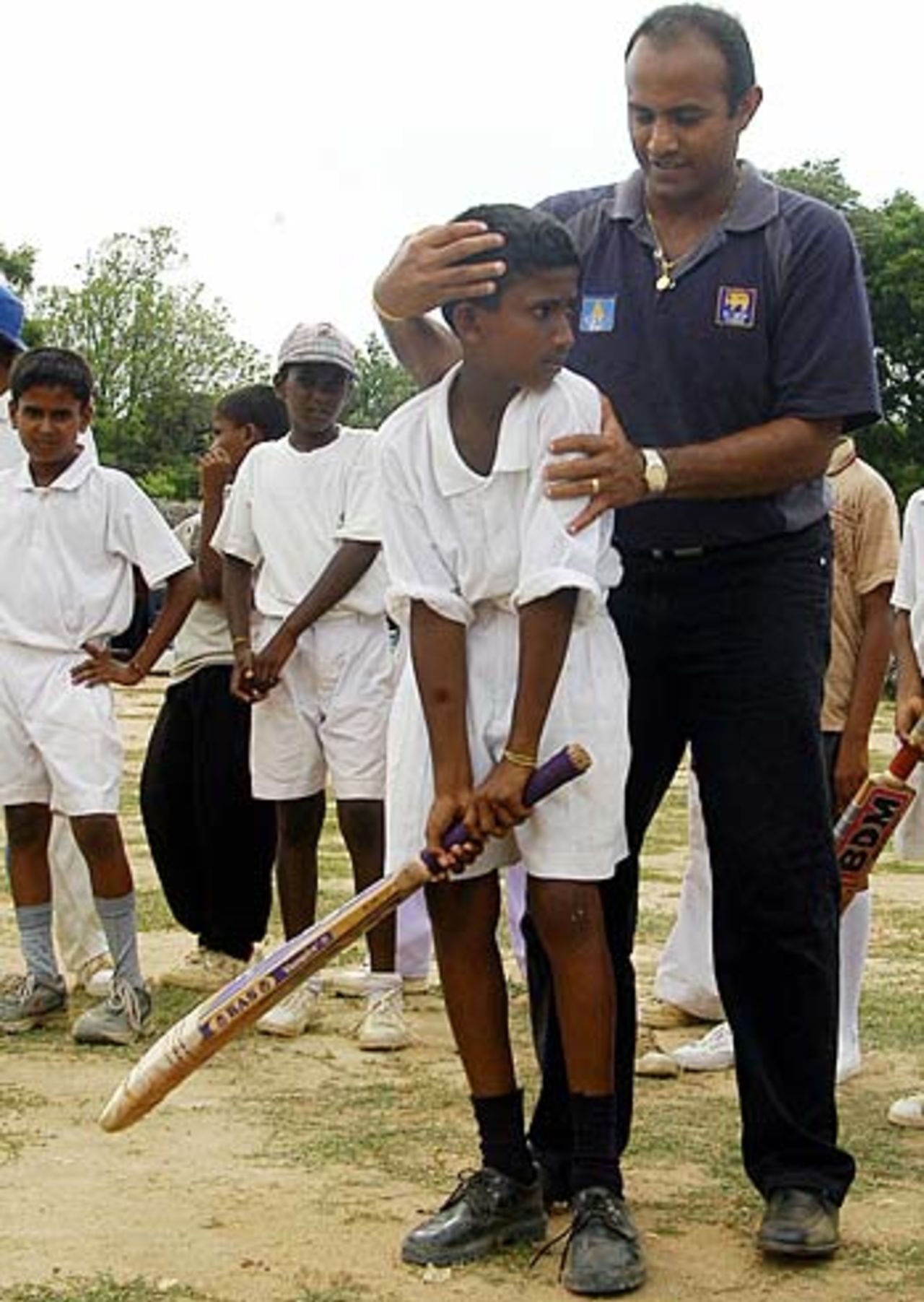 Hashan Tillakaratne coaches a Tamil youngster in the rebel-held town of Kilinochchi in northern Sri Lanka, May 8, 2005