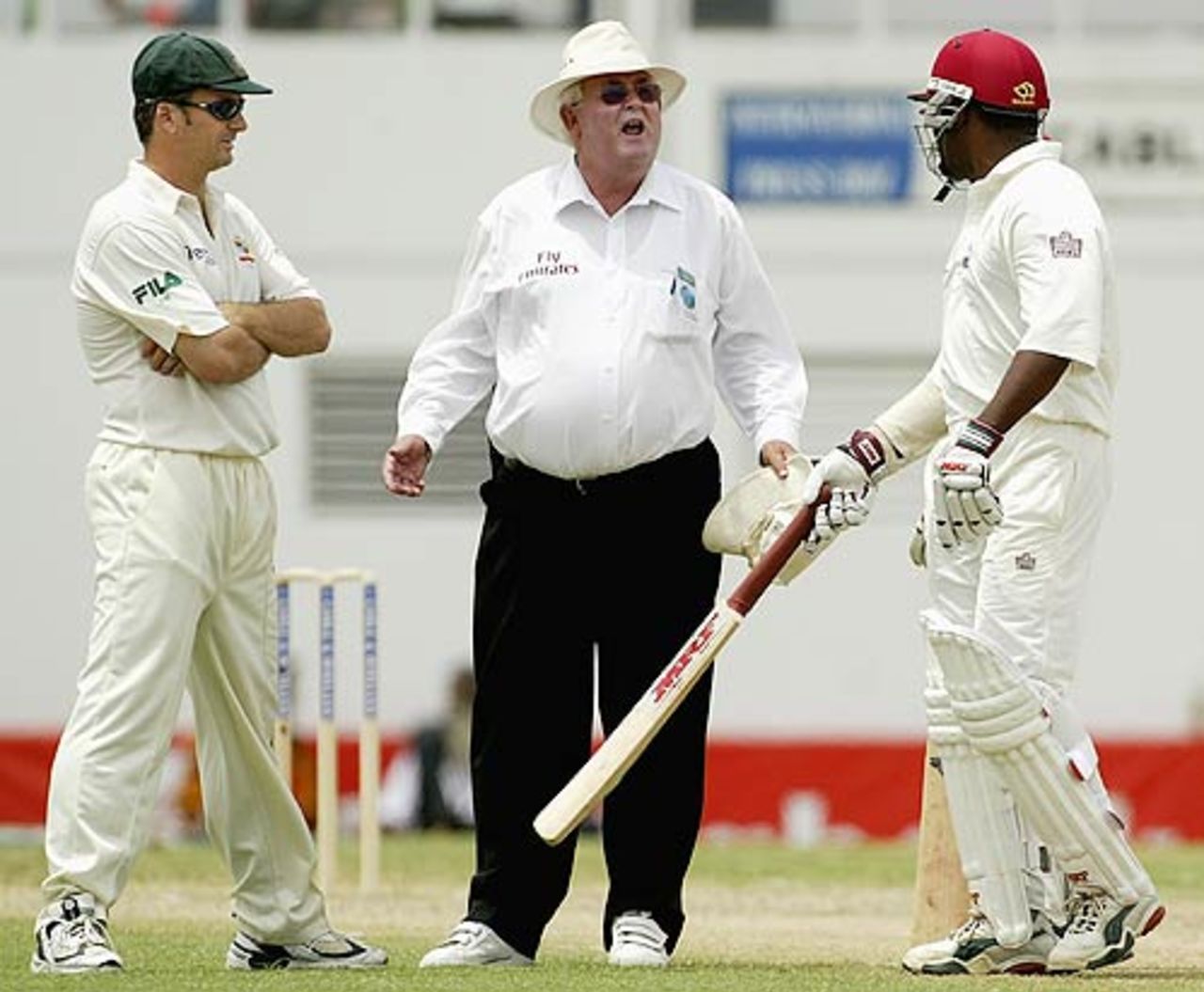 What are you fighting for? Shepherd plays referee and stops a bout between Steve Waugh and Brian Lara in Antigua, May 10, 2003
