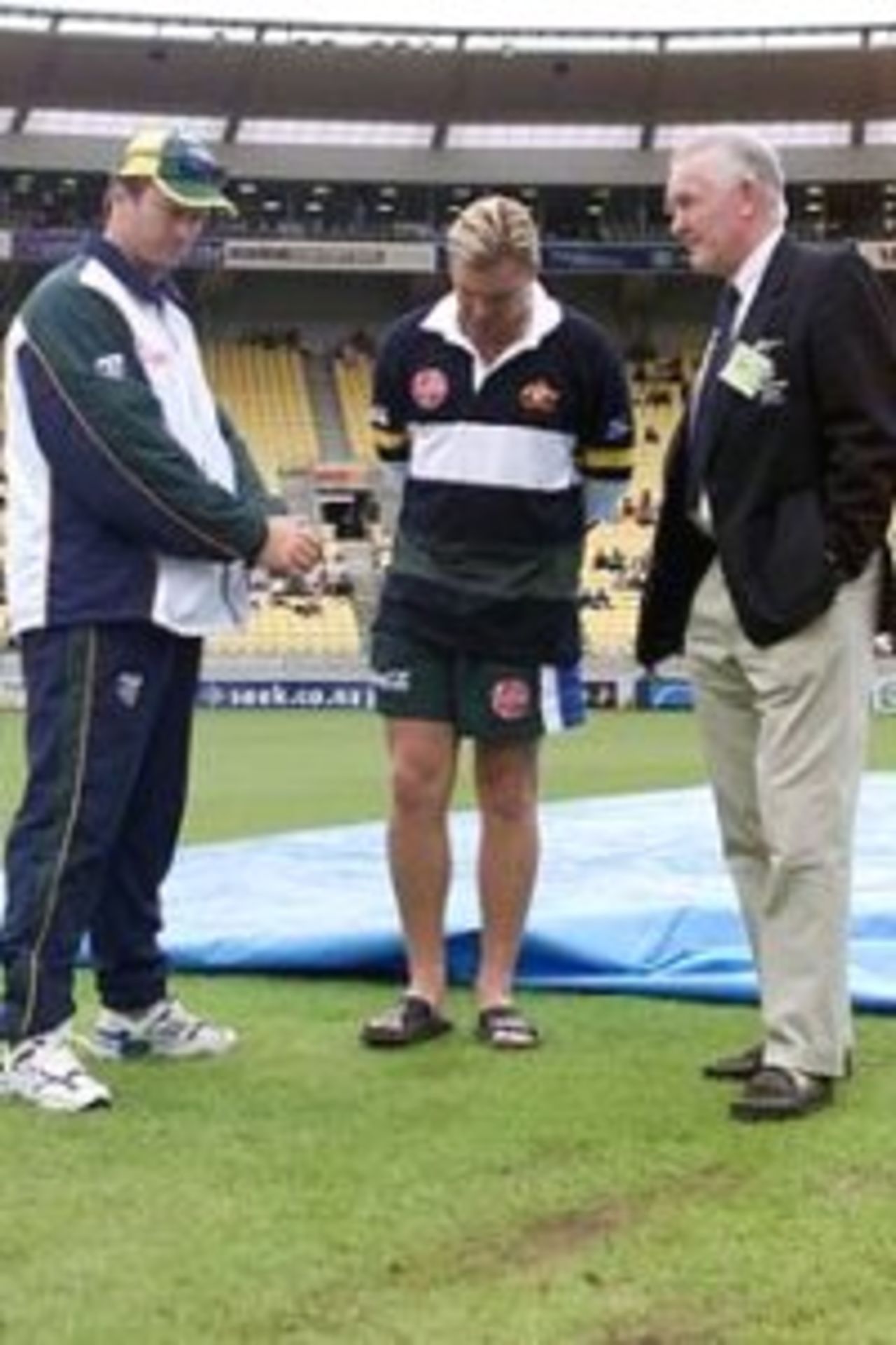 Australian captain Steve Waugh (left), vice captain Shane Warne (centre) inspect the wet run ups with ICC match referee Mike Denness (right), before the first one day international between Australia and New Zealand was abandonned at WestpacTrust Stadium, Wellington, February 16, 2000