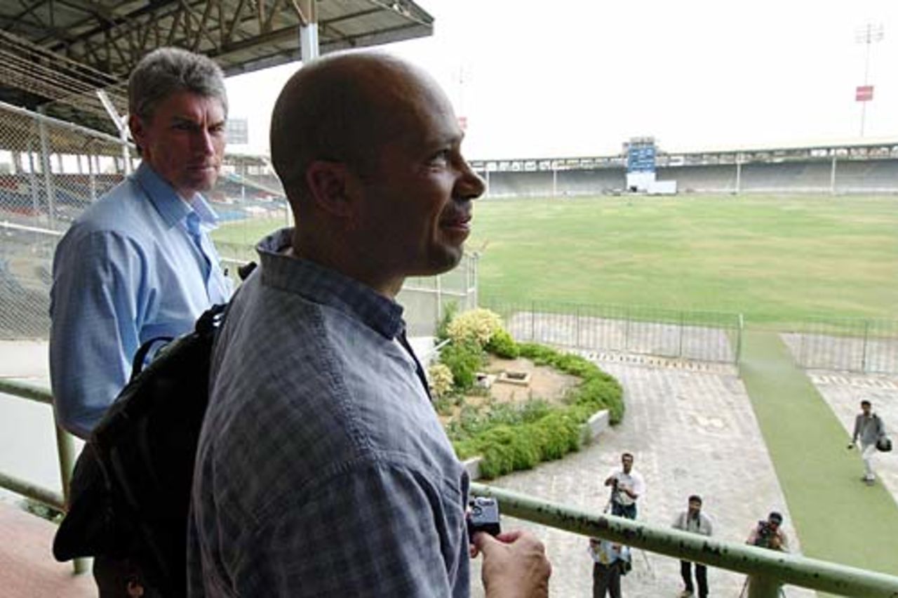 English security experts Douglas Dick and  Andy Allman look out over Karachi's National Stadium, June 28, 2005