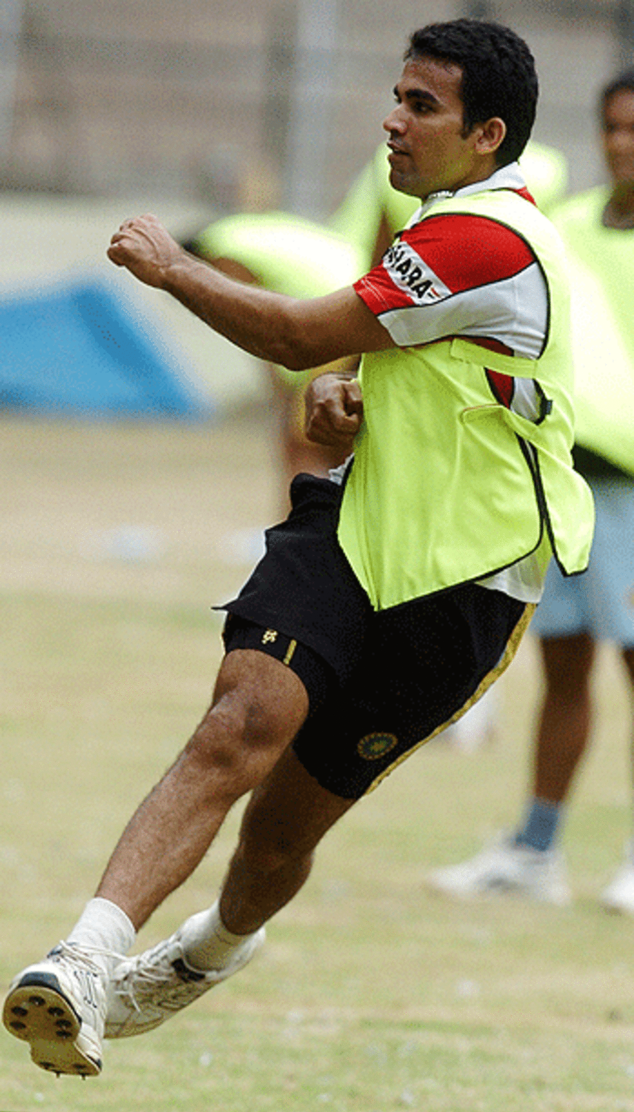 Zaheer Khan leaps in the air after fielding the ball during a practice session, Bangalore, July 7, 2005