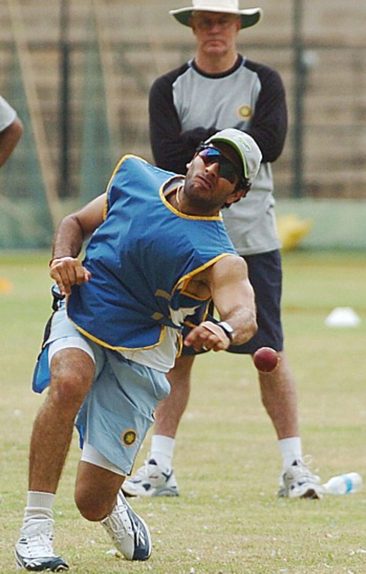 Yuvraj Singh takes aim under the watchful gaze of Greg Chappell