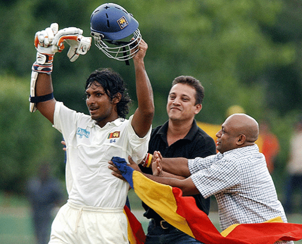 Kumar Sangakkara (L) acknowledges the crowd after completing 100 runs during the third day's play of the second and final Test match between Sri Lanka and the West Indies at the Asgiriya cricket grounds in Kandy, 24 July 2005
