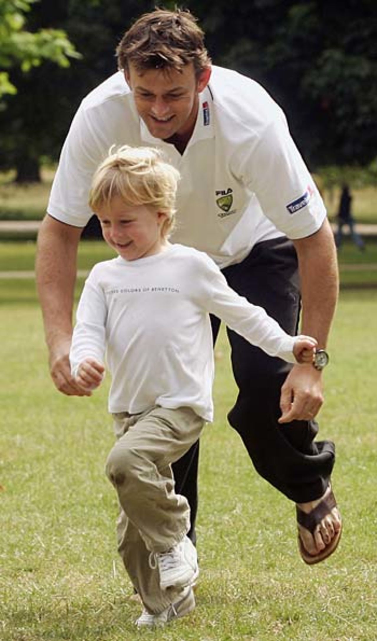 Adam Gilchrist chases his son Harry in Kensington Gardens, July 26, 2005