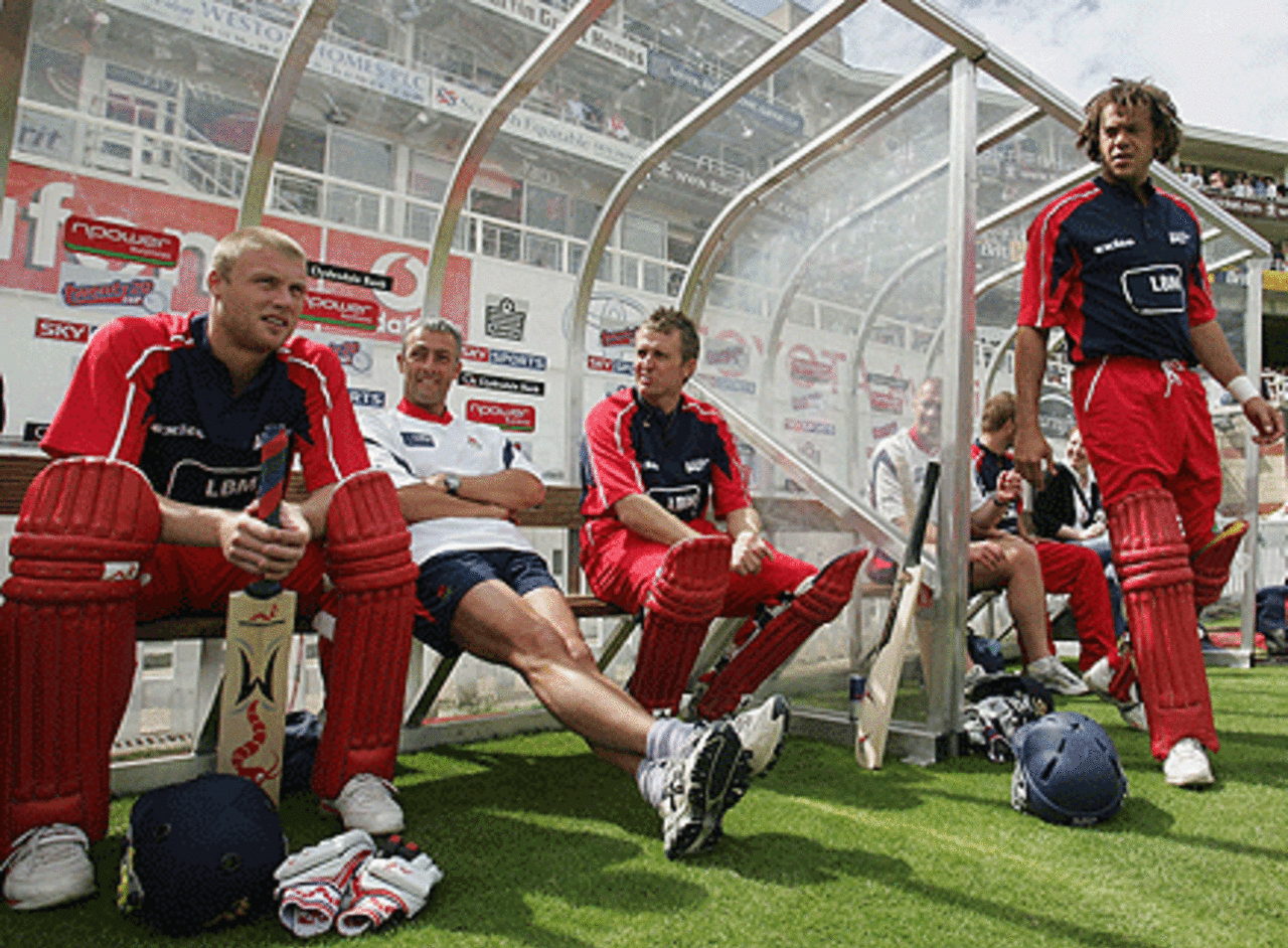 Andrew Flintoff, Dominic Cork and Andrew Symonds await their turn to bat in the Twenty20 semi-final between Lancashire and Surrey at The Oval, July 30, 2005