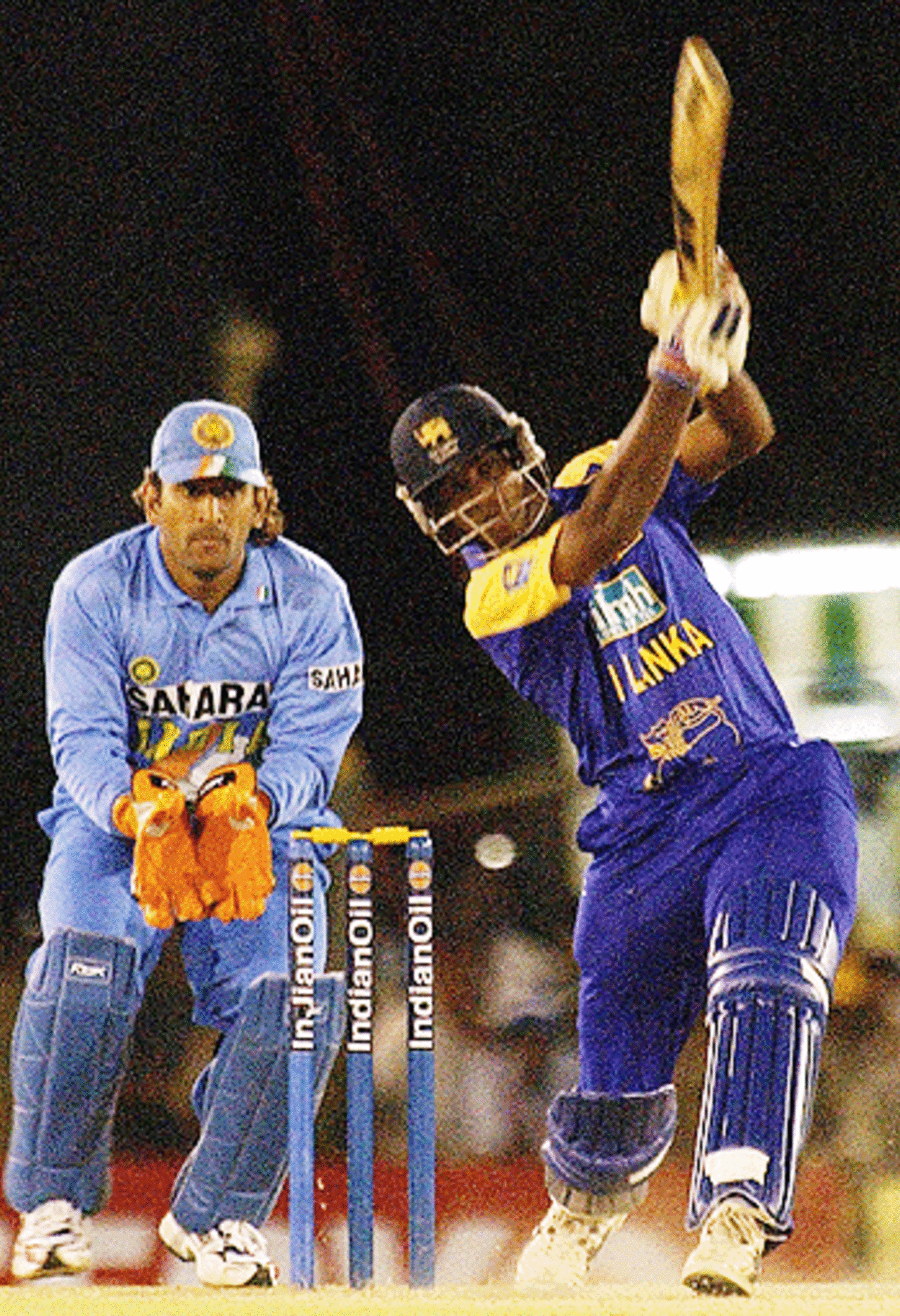 Dilhara Lokuhettige hits a six in during an invaluable cameo against India at the Dambulla Cricket Stadium, July 30, 2005