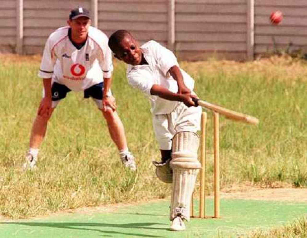 Nick Knight watches from slip as a young Zimbabwean displays his batting talent during a coaching session organized to mark the sponsorship of schools cricket in Zimbabwe by CricInfo