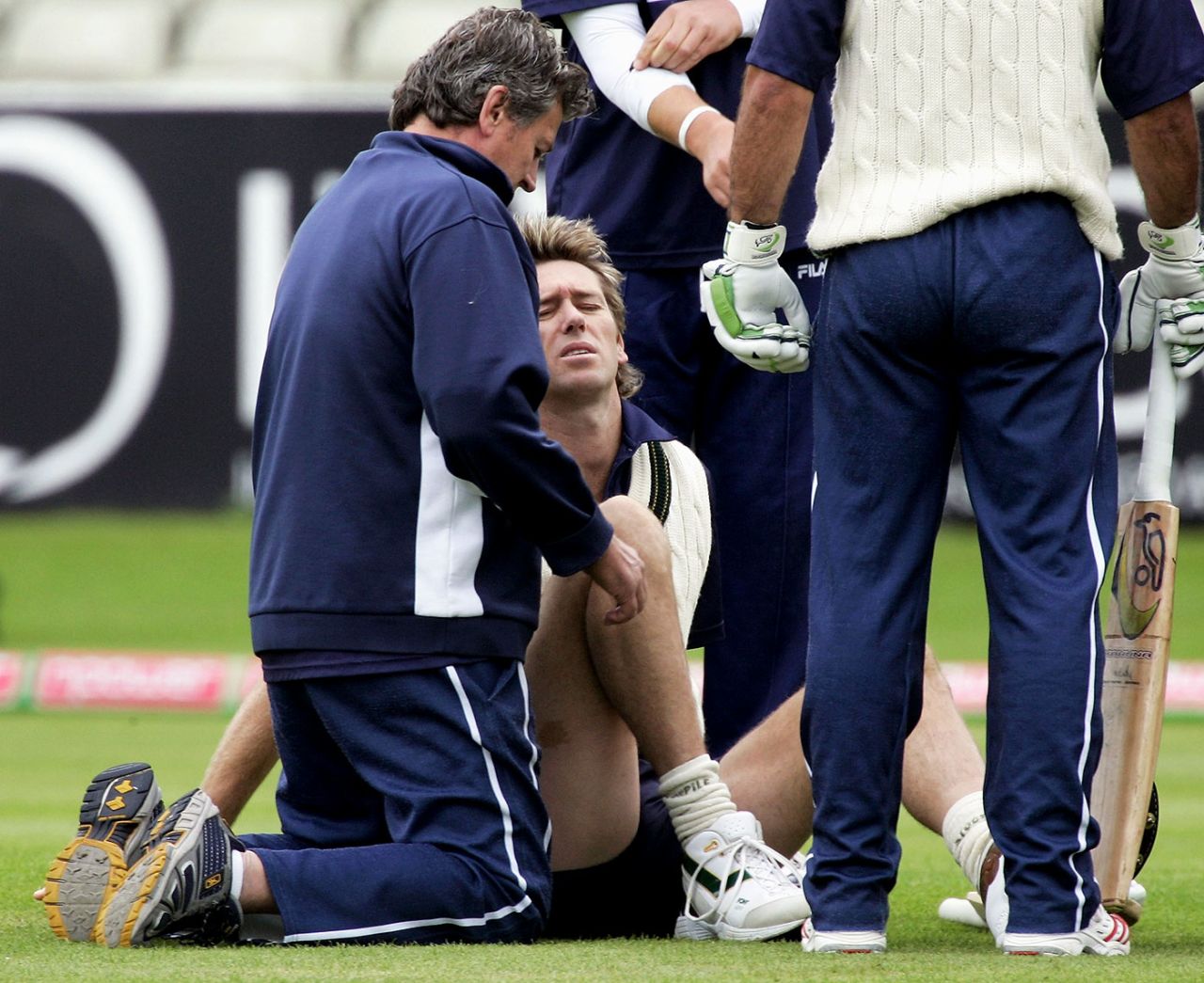 The physio has a look at Glenn McGrath's injured ankle, England v Australia, Edgbaston, August 4, 2005