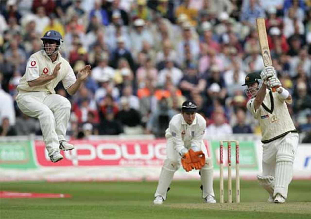 Andrew Strauss jumps to avoid a cracking drive from Damien Martyn
