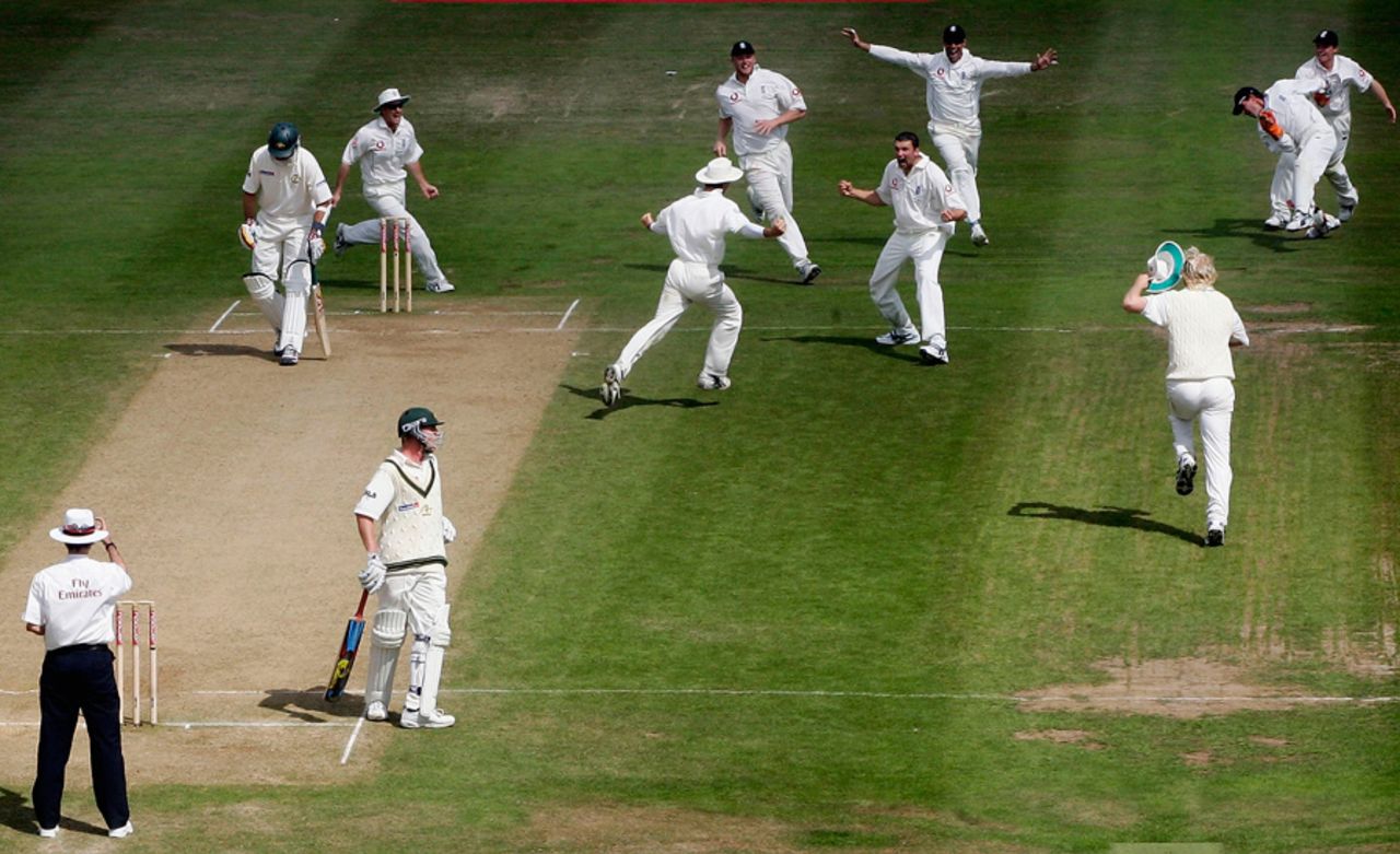 England's players mob Steve Harmison after he took the final wicket in dramatic style, England v Australia, Edgbaston, August 7, 2005