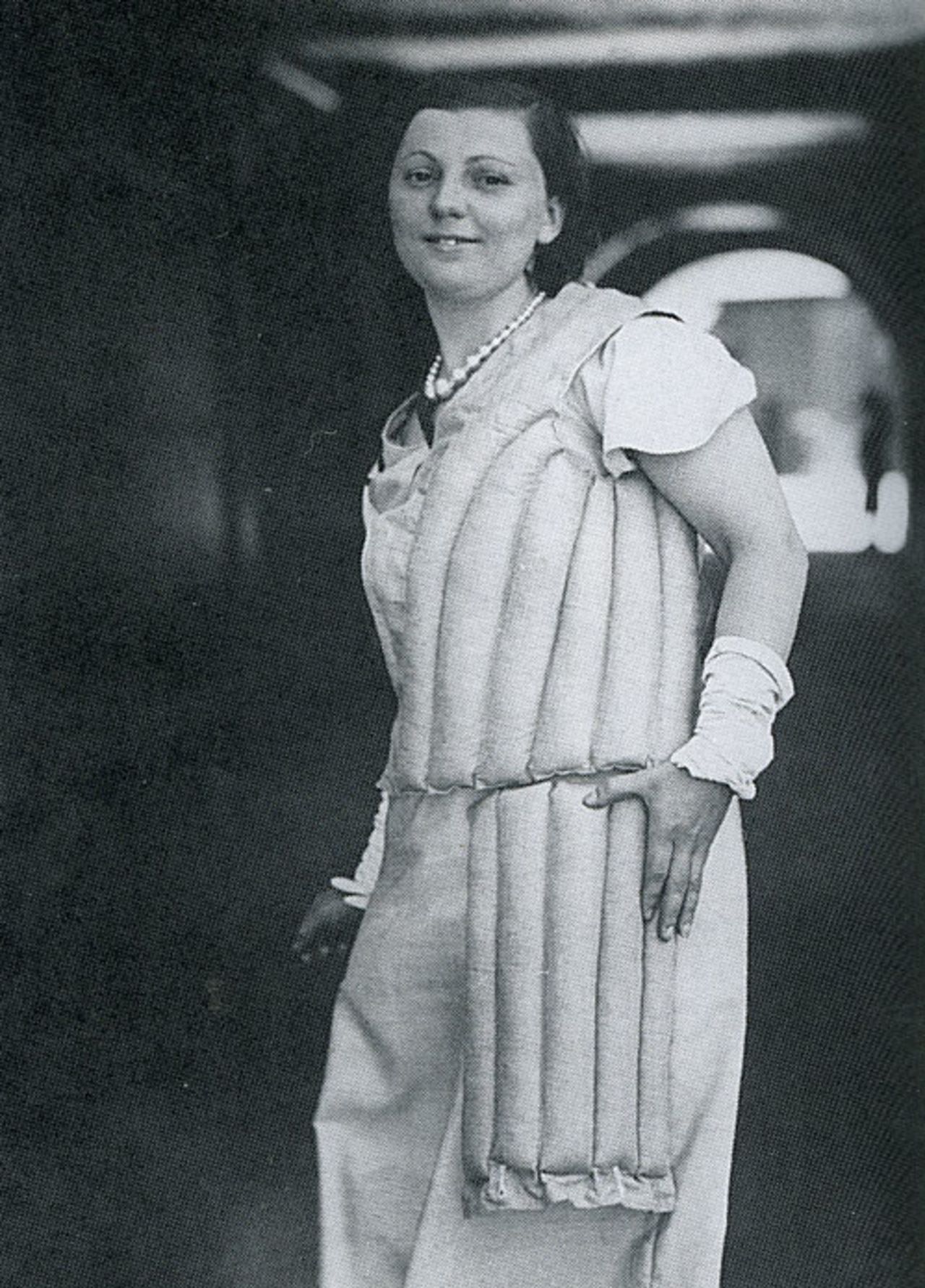A female model demonstrates the protection used by Australian batsmen during the Bodyline series, December 1932