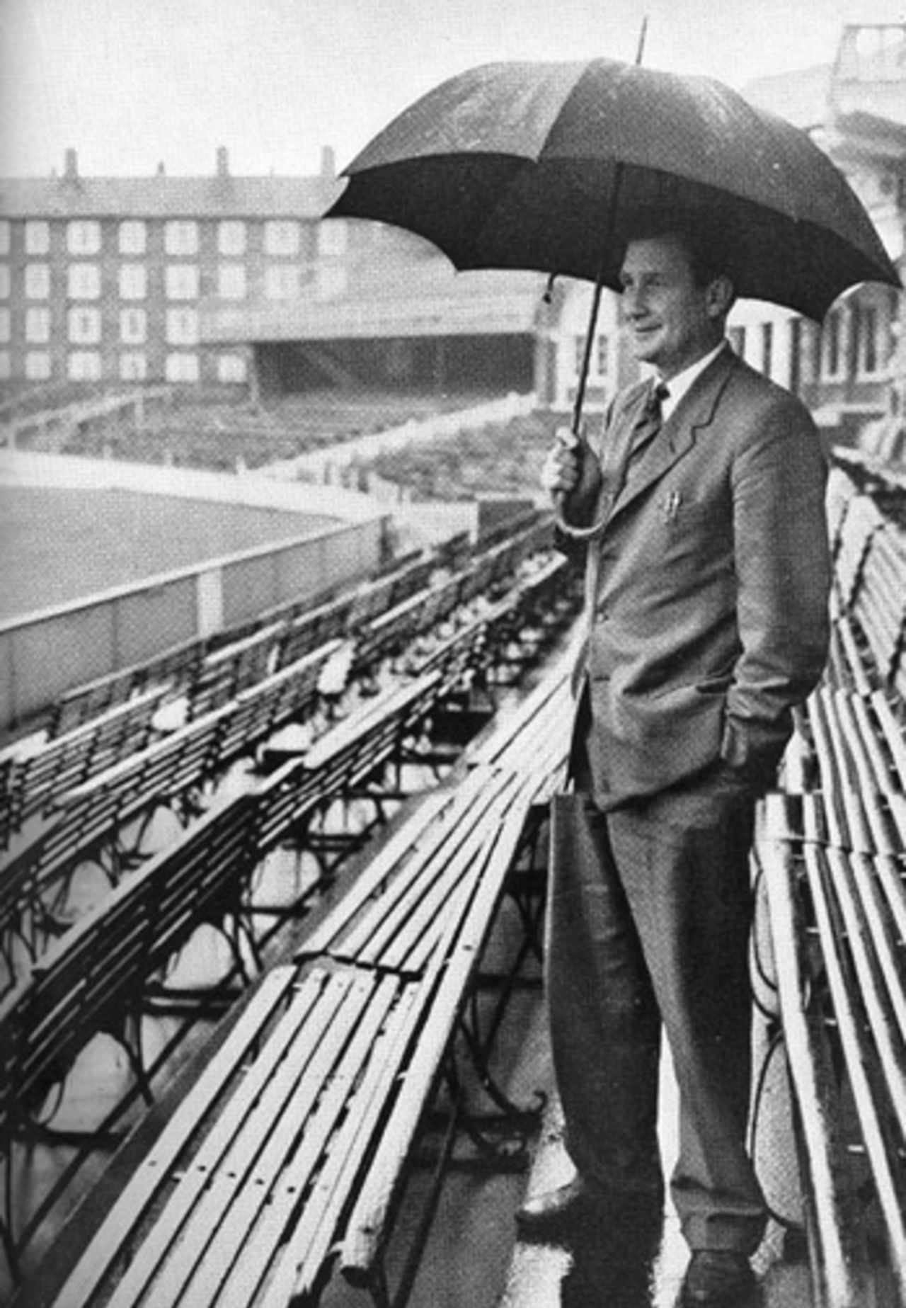 Jim Laker ruefully looks across The Oval as his benefit match is washed out, 1956
