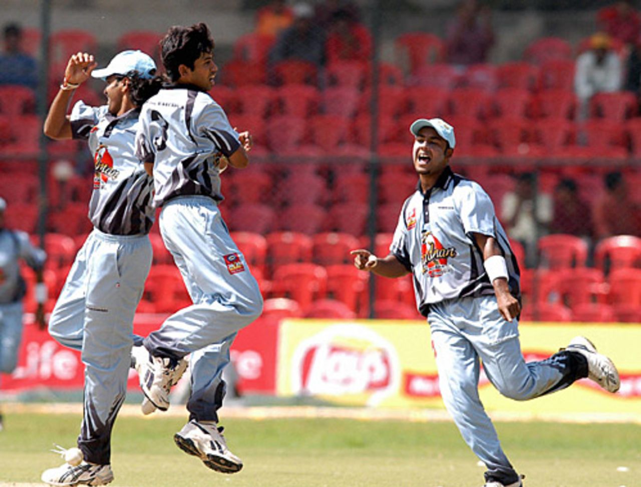 Cricketers from the Karnataka State Cricket Association XI celebrate their victory over the Bradman World XI, Bangalore, August 20, 2005
