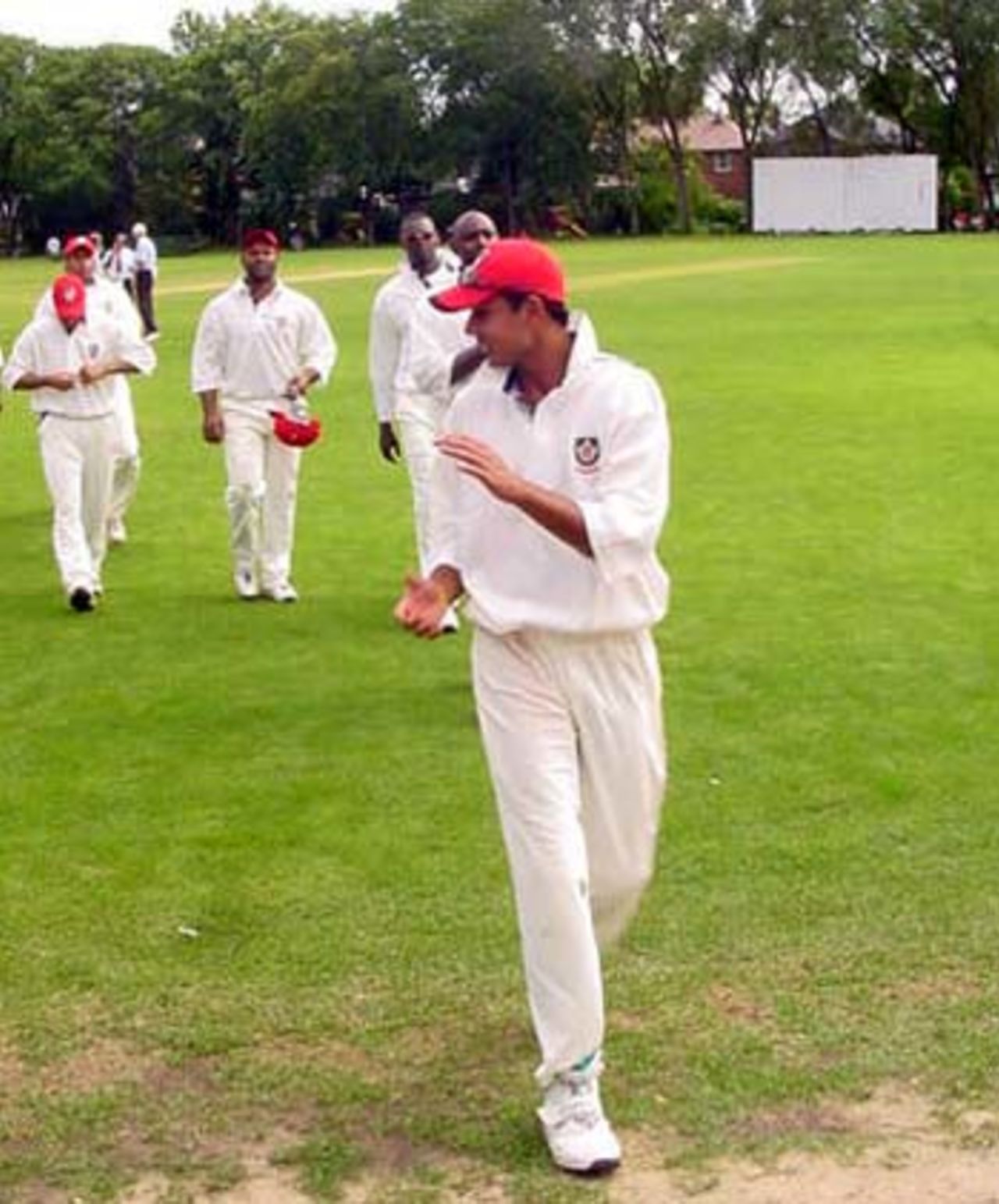 Umar Bhatti leads the Canadian team off the field after taking 8 for 40, Canada v Bermuda, Toronto, August 23, 2005