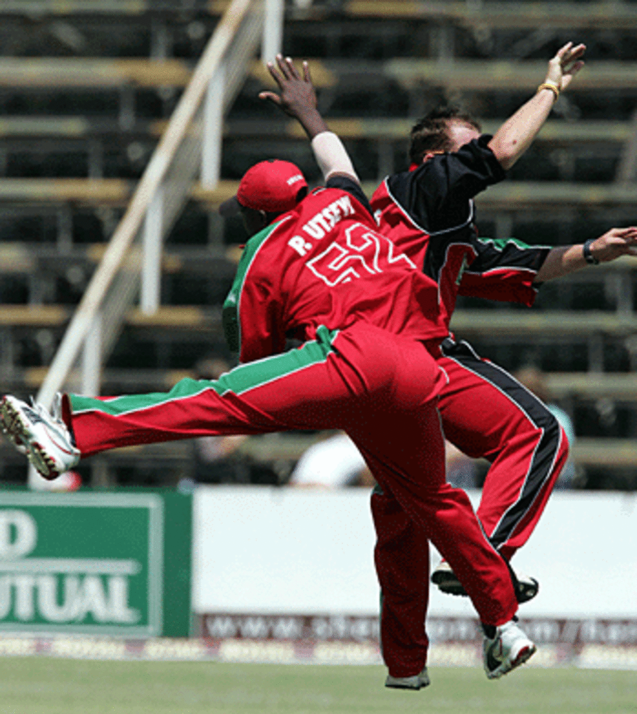 Prosper Utseya and Gaving Ewing are overjoyed at Nathan Astle's wicket, Zimbabwe v New Zealand, Harare, August 31, 2005