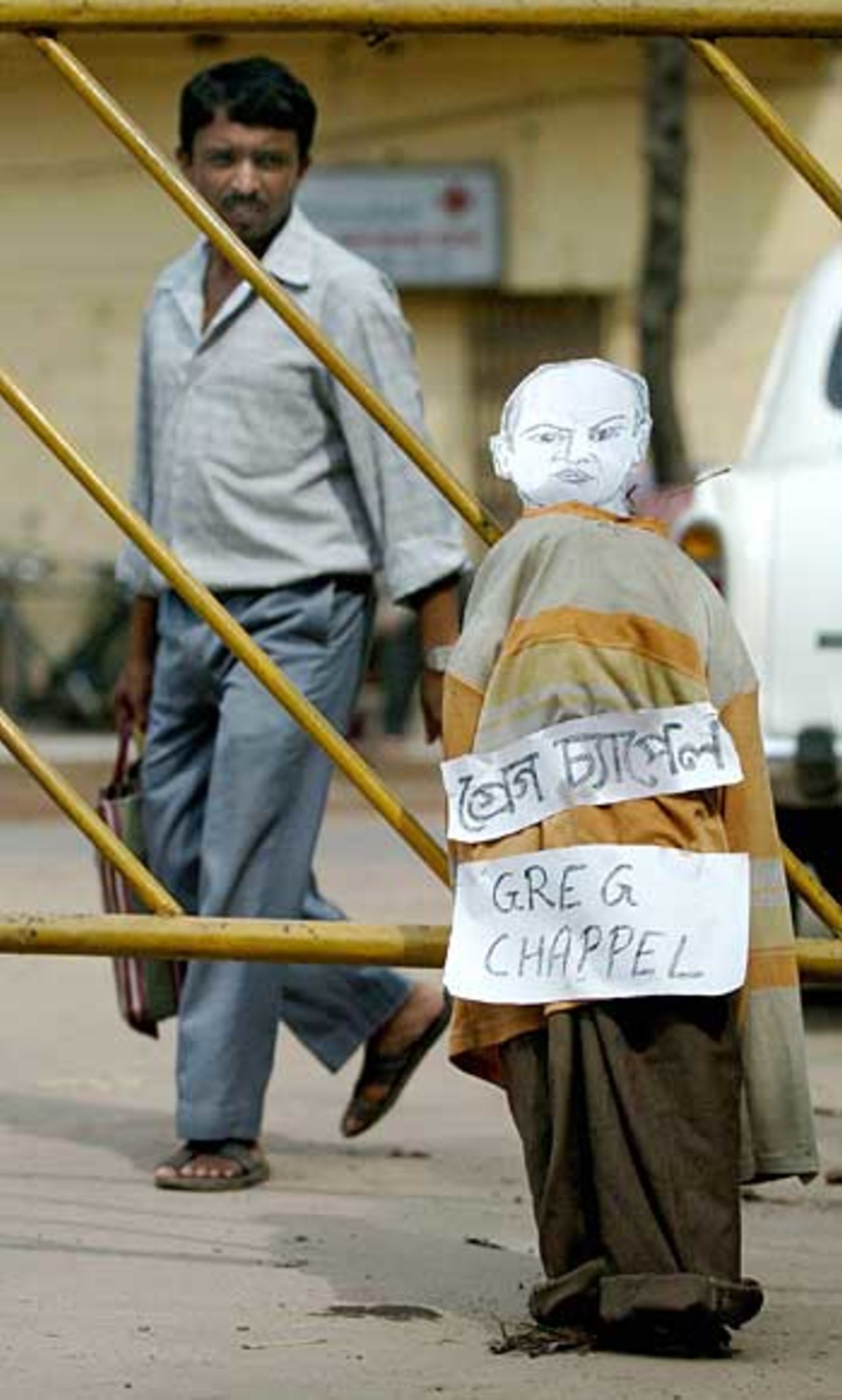 An Indian man walks past an effigy of Indian Greg Chappell which was being kept ready for a demonstration in Kolkata, 24 September 2005