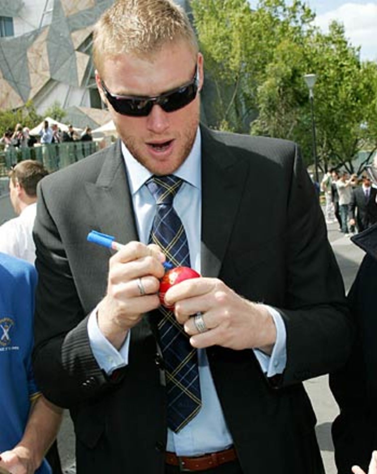 Andrew Flintoff signs a cricket ball at the unveiling of the ICC Super Series Trophy, Melbourne, October 3, 2005