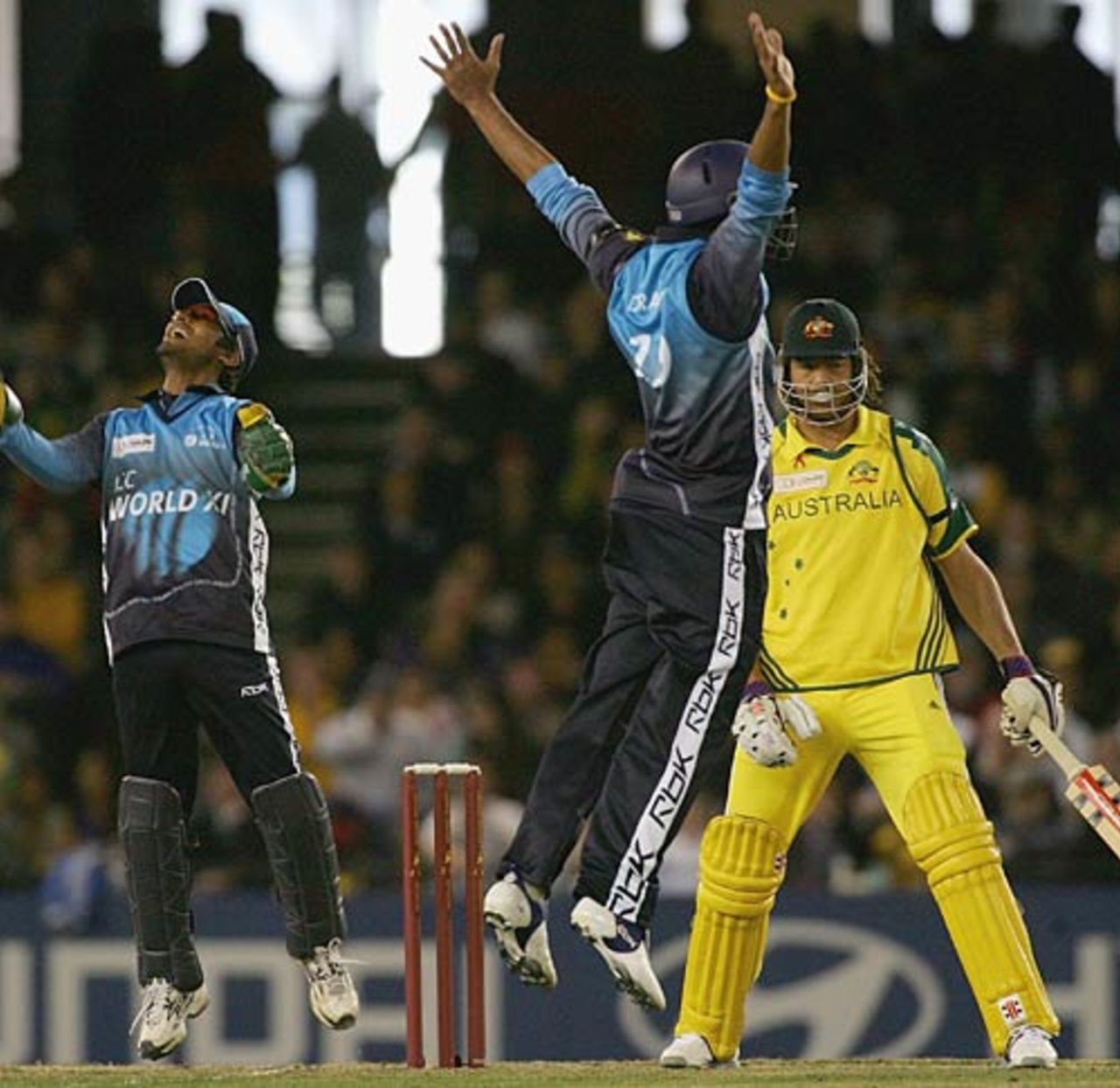 Kumar Sangakkara and Rahul Dravid celebrate the wicket of Andrew Symonds, Australia v World XI, Melbourne, October 9, 2005