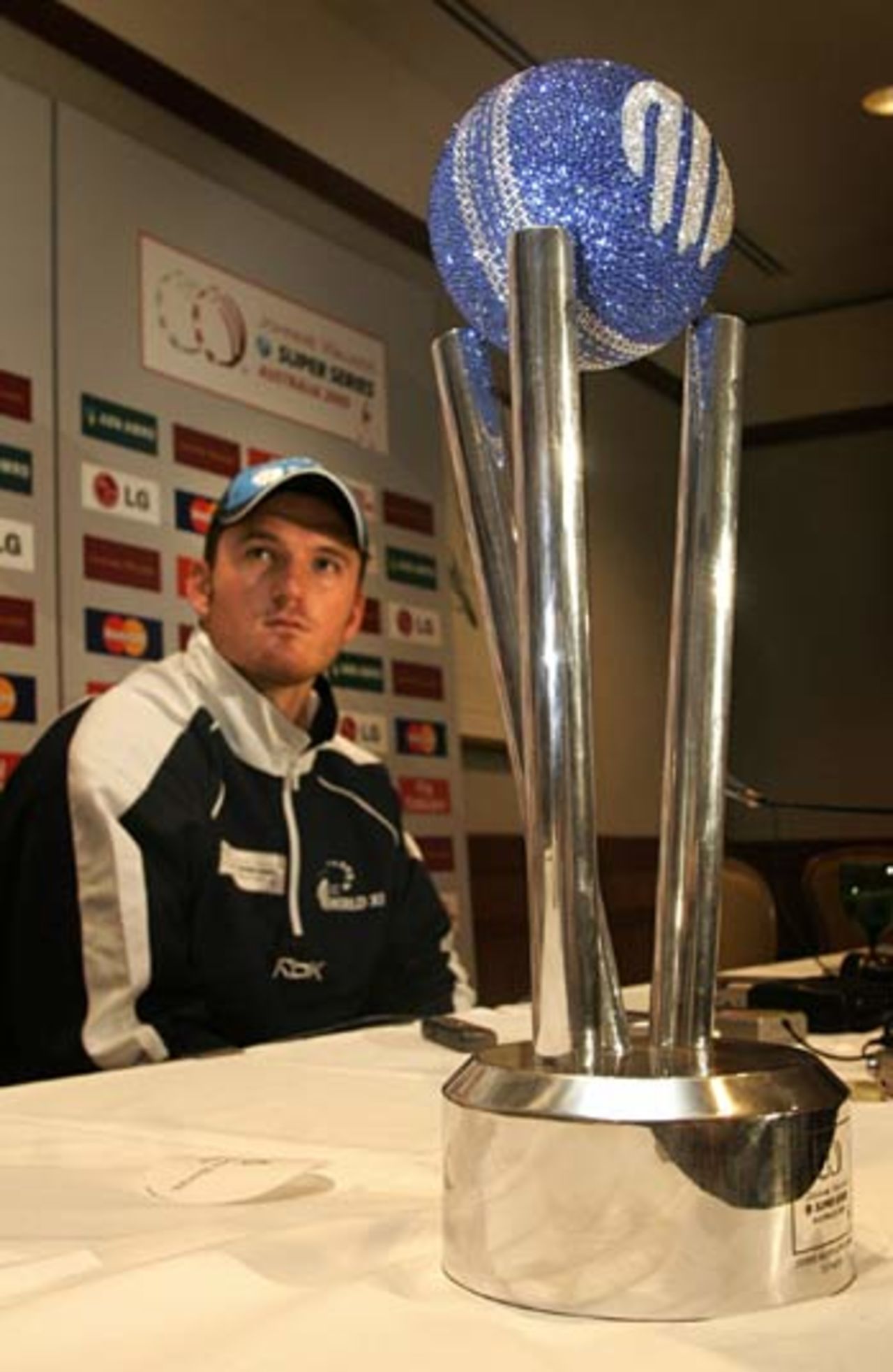 World XI cricket skipper Graeme Smith answers questions at a press conference next to the ICC World Test trophy, Sydney, October 13, 2005