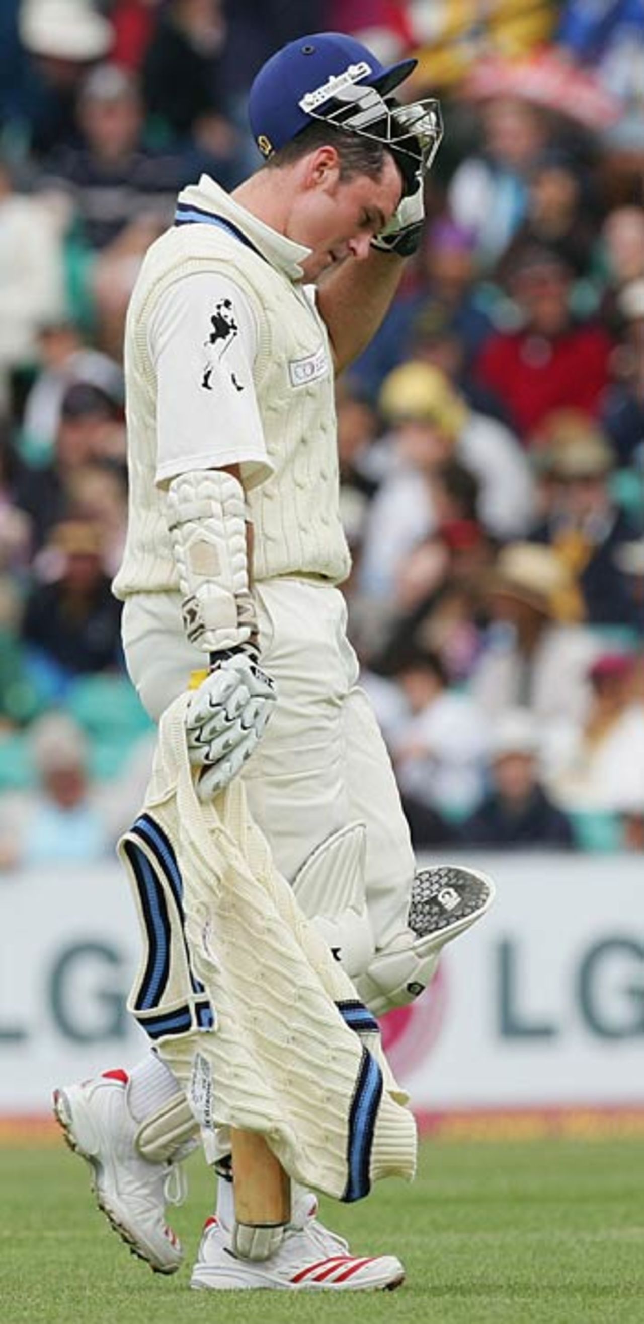 Graeme Smith walks back disappointed after holing out to Adam Gilchrist off Brett Lee