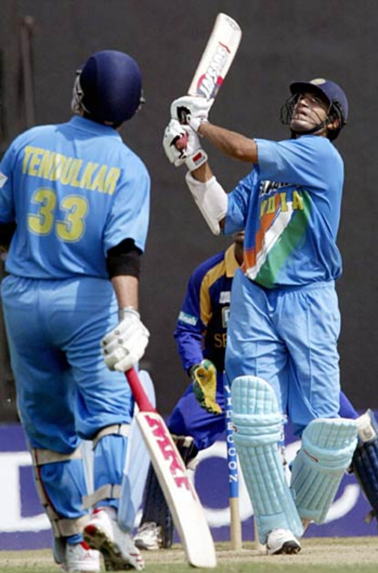 Irfan Pathan launches a six over midwicket fence as Sachin Tendulkar looks on, India v Sri Lanka, Videocon Cup, 1st ODI, Nagpur, October 25, 2005