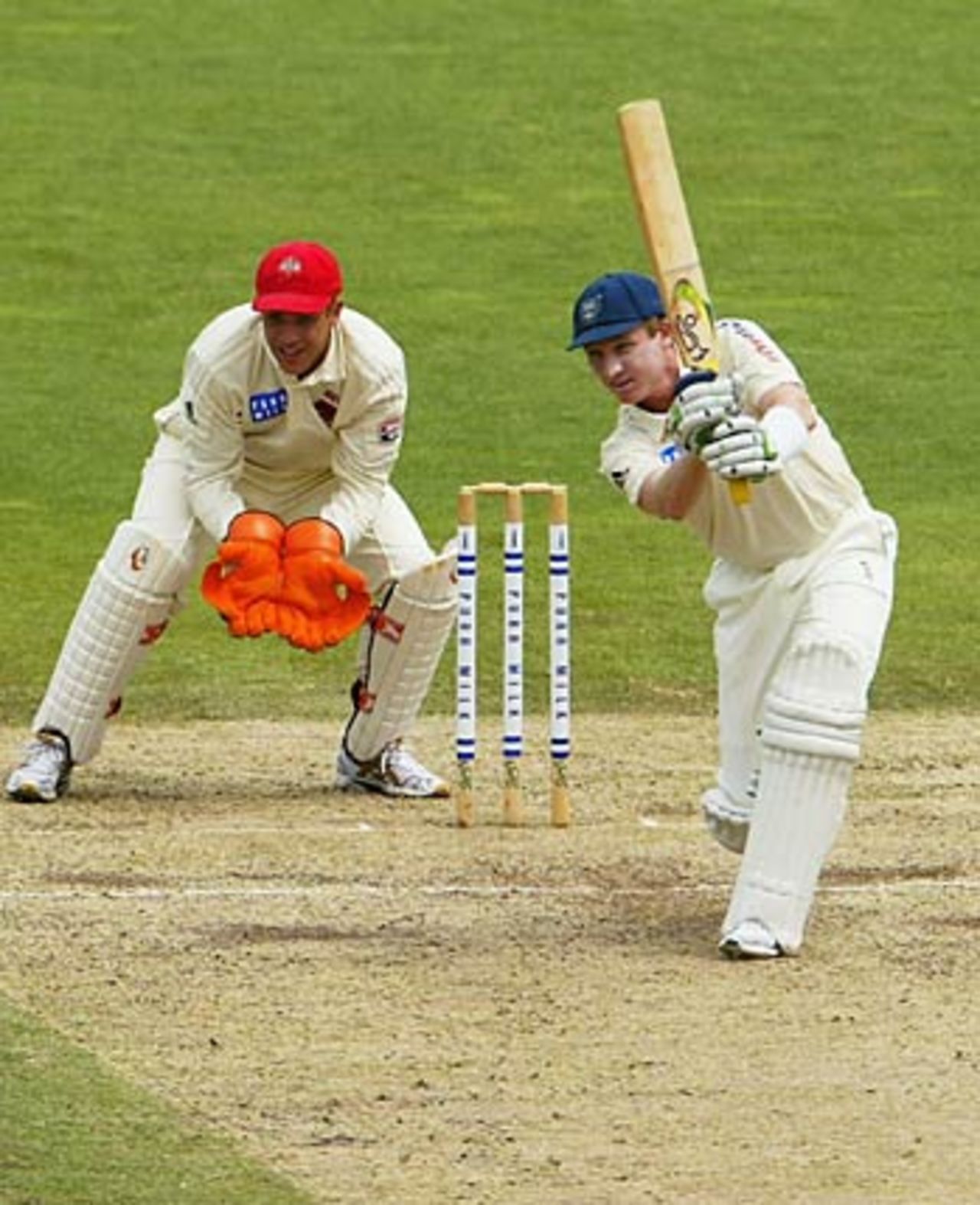 Brad Haddin cover drives as Graham Manou looks on, New South Wales v South Australia, Pura Cup, Sydney, 2nd Day, Oct 25, 2005