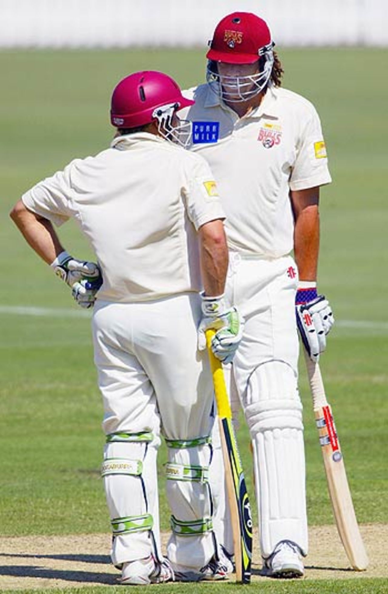 Andrew Symonds and Chris Hartley of Queensland talk tactics, Queensland v West Indians, Alan Border Oval, Brisbane, 1st day, October 27, 2005