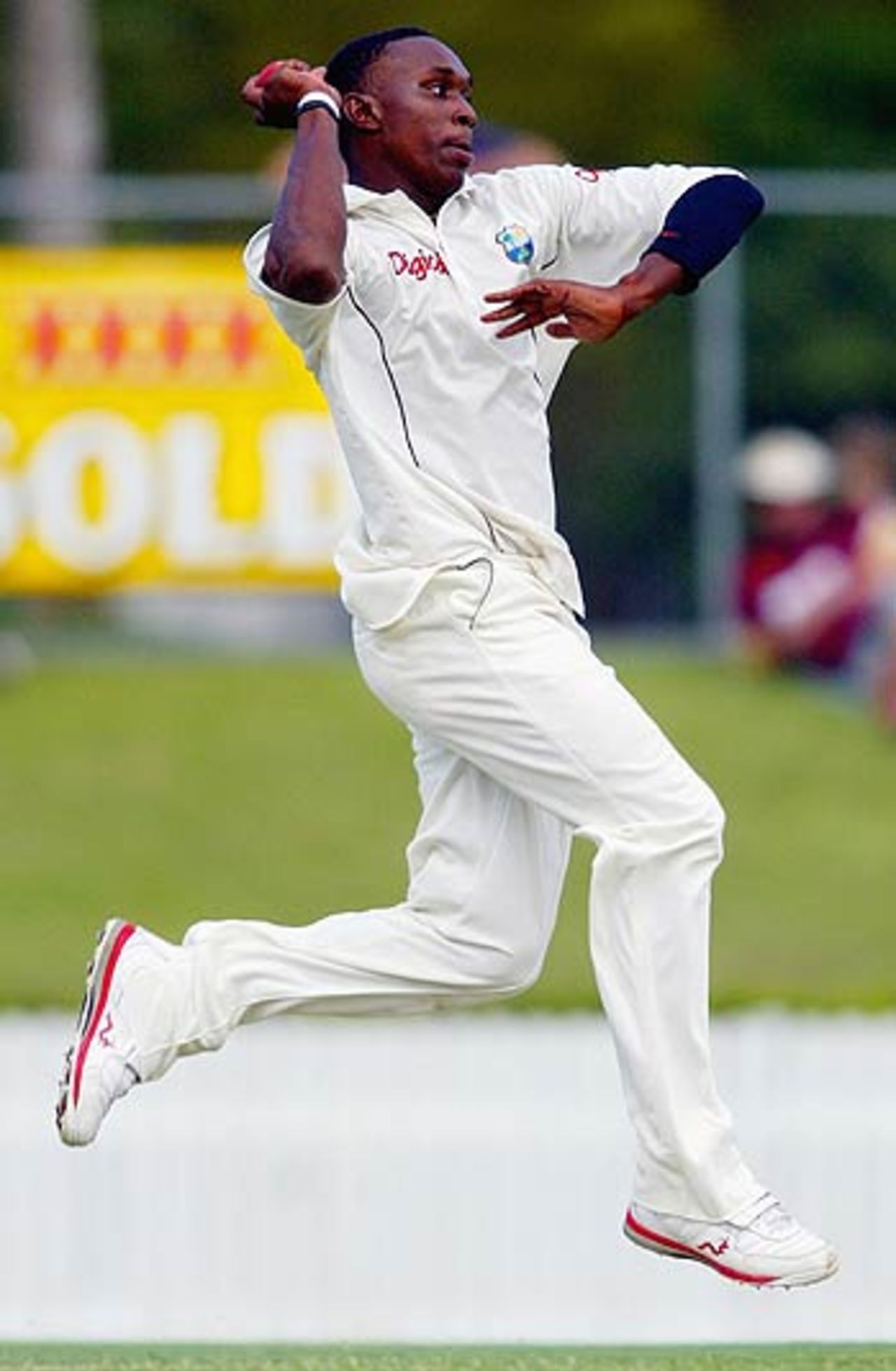 Dwayne Bravo cuts a classic figure as he delivers a ball, Queensland v West Indians, Alan Border Oval, Brisbane, 1st day, October 27, 2005
