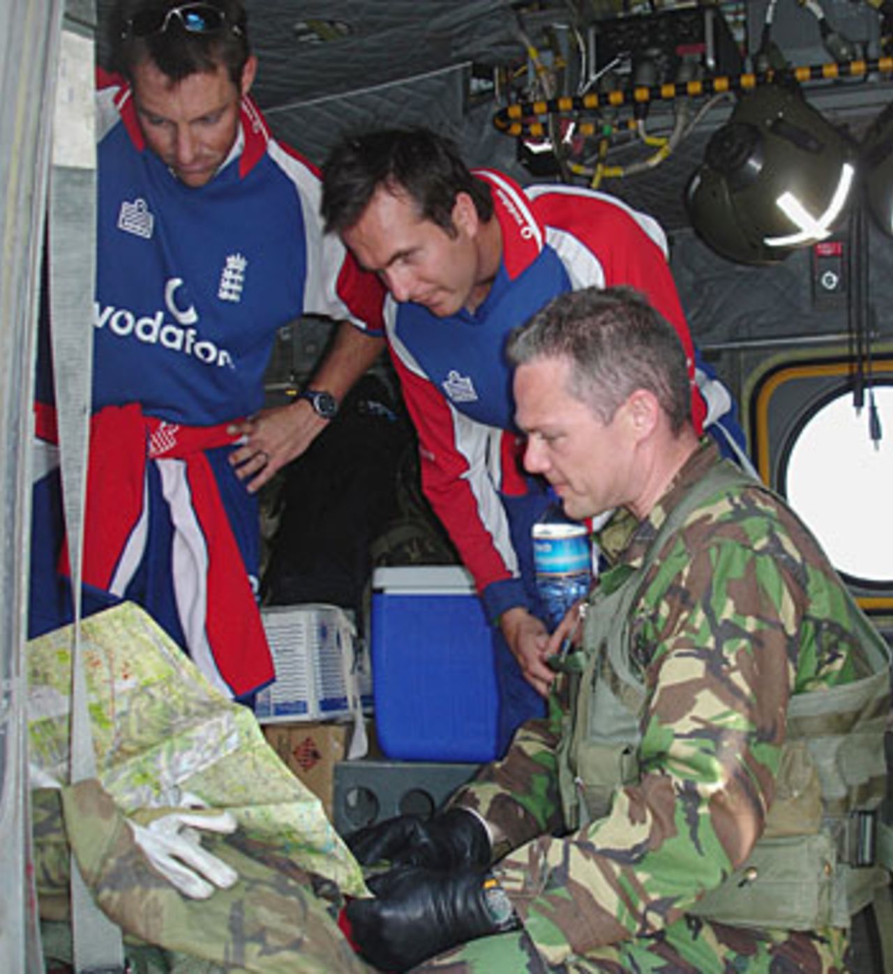 Marcus Trescothick and Michael Vaughan receive a briefing before helping to unload an RAF Chinouk in the Bagh Region of Northern Pakistan that was hit by an earthquake, October 30, 2005