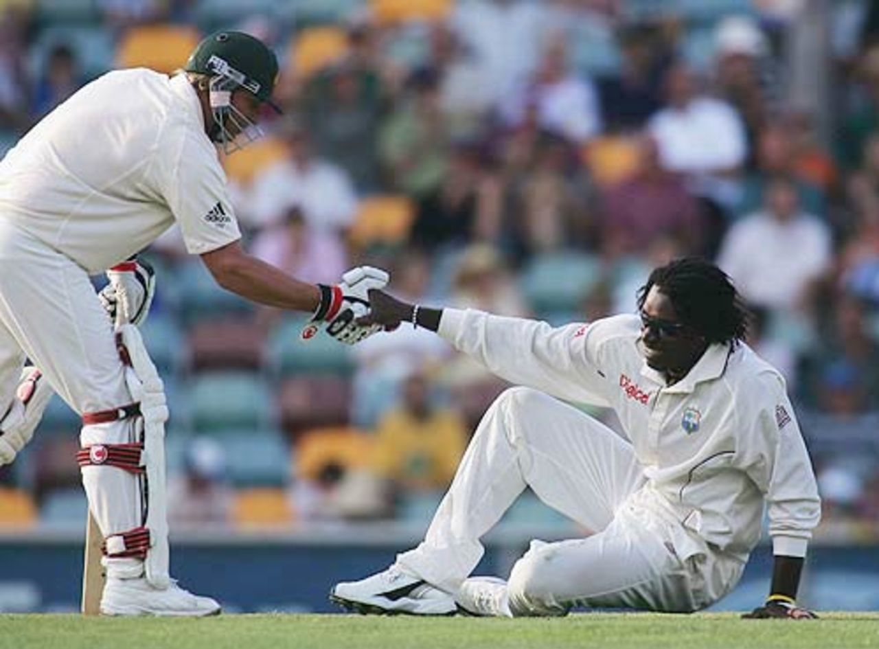 Shane Warne picks up Chris Gayle after a collision in which Gayle dropped a return catch, 1st Test, Brisbane, 1st day, November 3, 2005