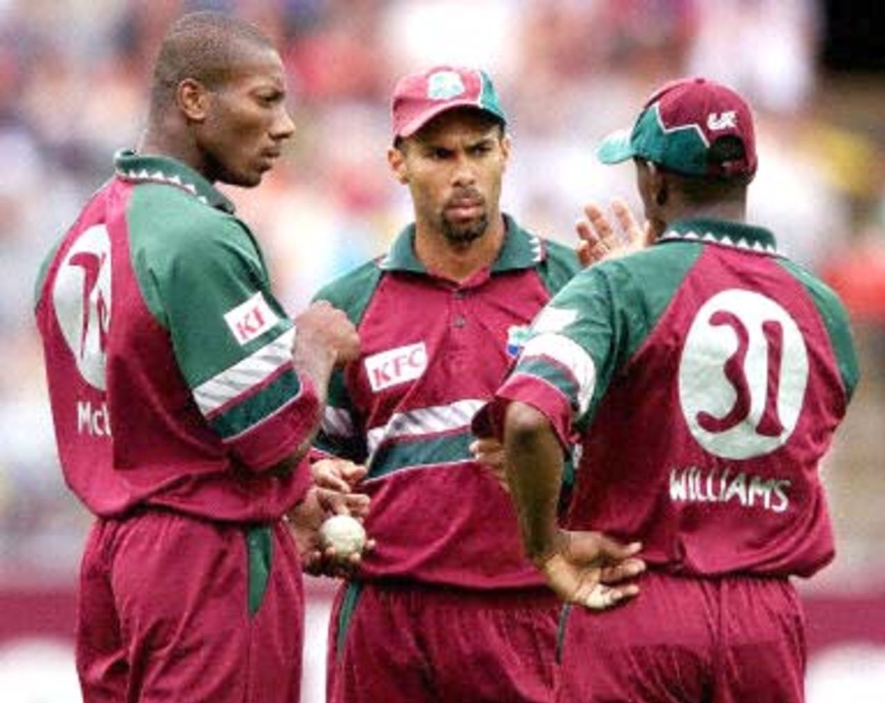 West Indian captain Jimmy Adams (C) discusses with his bowlers Nixon McLean (L) and Laurie William (R) how to stop the onslaught from the Australian batsmen during the 2nd one-day final against the West Indies at the MCG in Melbourne 09 February 2001. Australia amassed the huge total of 338-6 with Mark Waugh topscoring with 173.