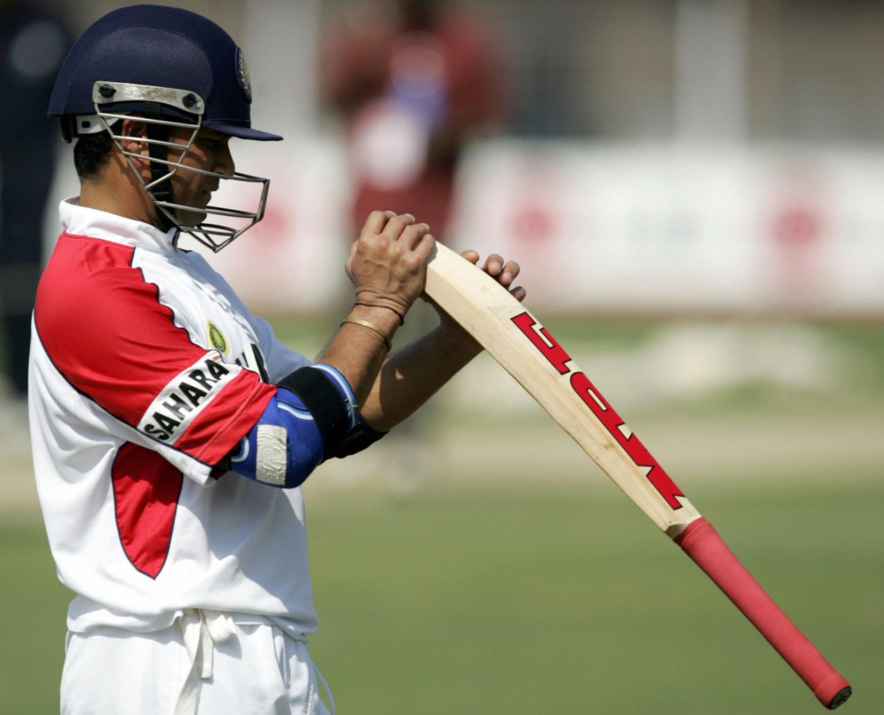 Sachin Tendulkar examines his bat before heading to the nets, Madhavrao Scindia Cricket Ground, Rajkot, November 8, 2005
