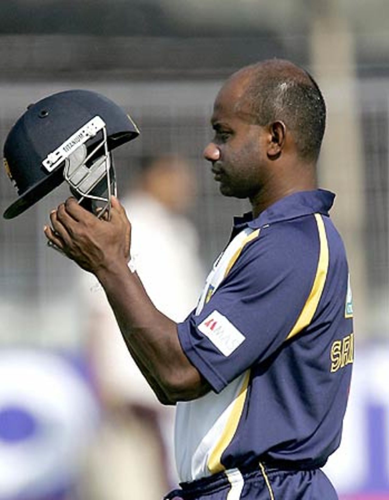 Sanath Jayasuriya finds something the bother with his helmet, Madhavrao Scindia Cricket Ground, Rajkot, November 8, 2005