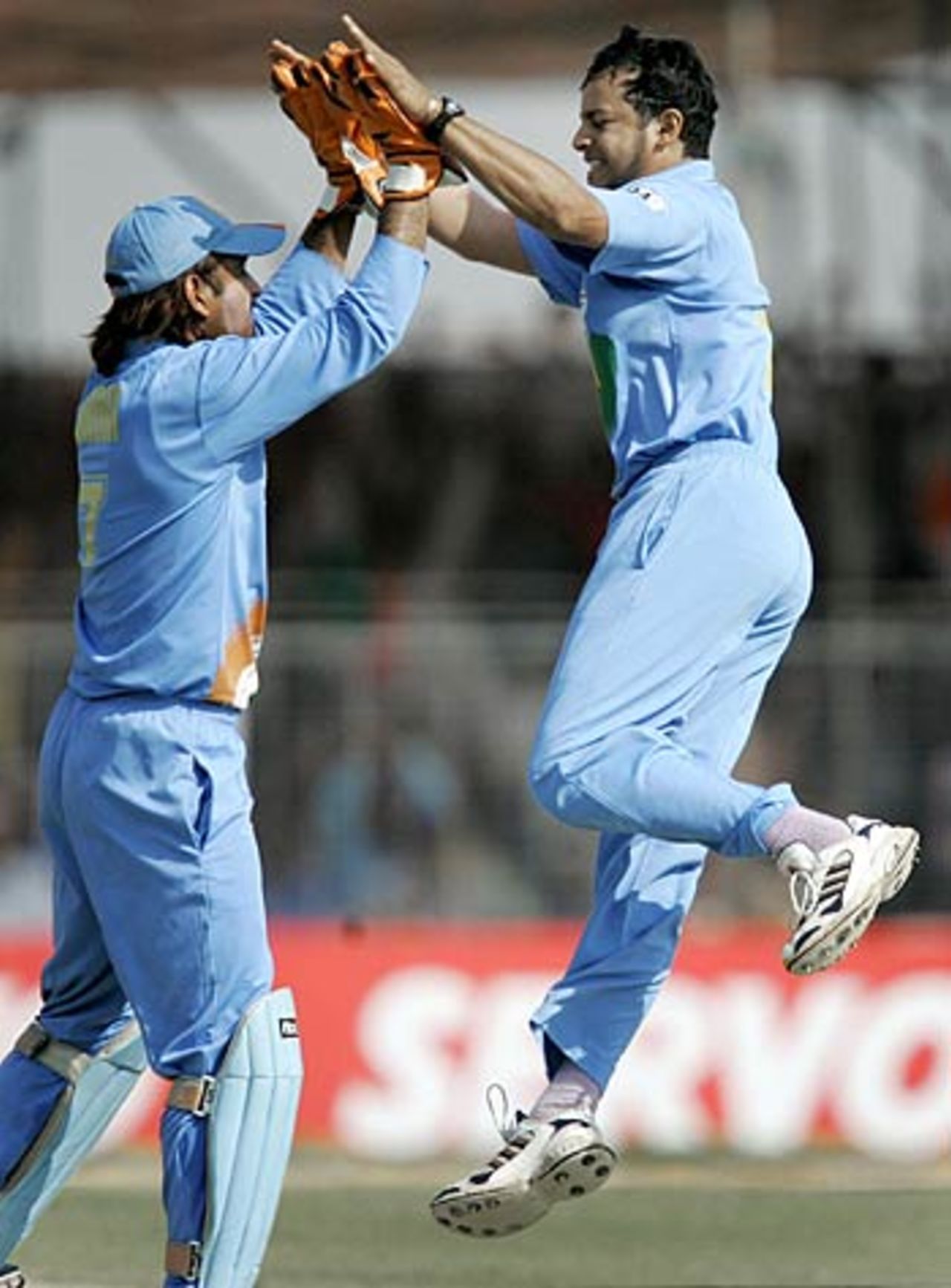 Mahendra Singh Dhoni and Murali Kartik celebrate a wicket in the 6th ODI at Rajkot, India v Sri Lanka, 6th ODI, Rajkot, November 9, 2005