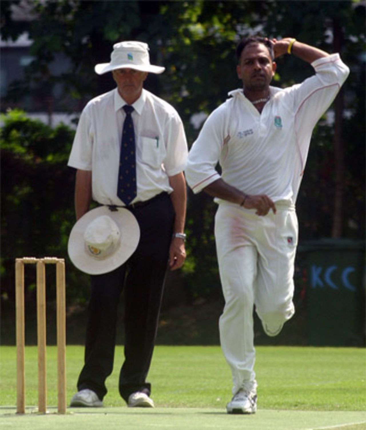 Naeem Ashraf bowling in the Chris Collins Cup 2005. Umpire is Alan Swift.