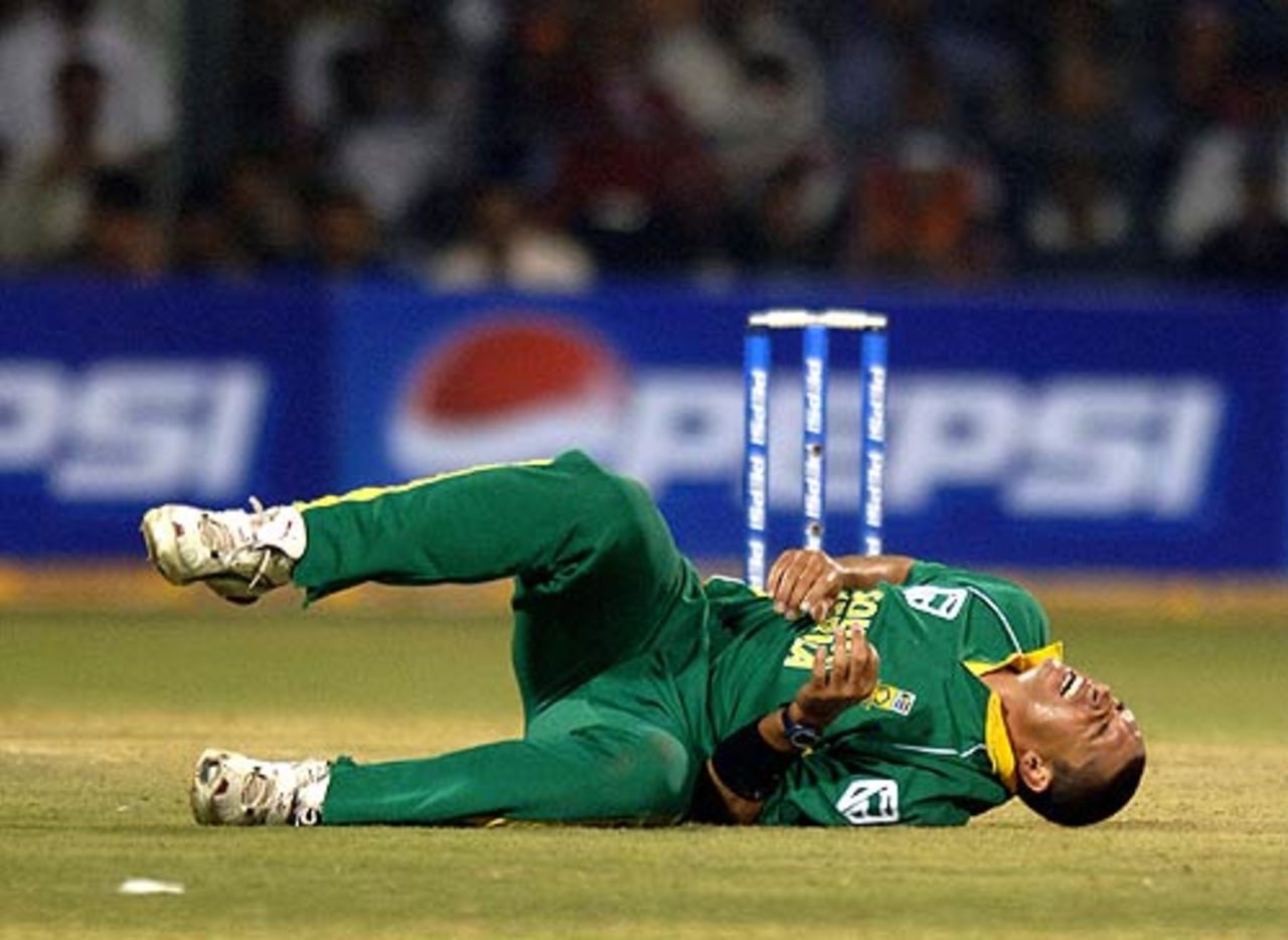 Andre Nel falls to the ground after delivering a ball, India v South Africa, 2nd ODI, Bangalore, November 19, 2005