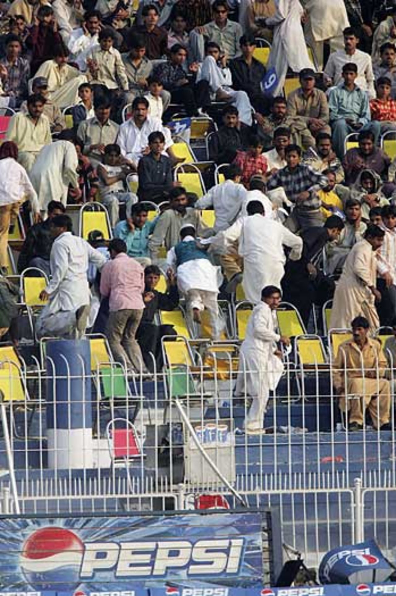 The crowd scatters after a gas cylinder explodes, halting play for about 10 minutes, Pakistan v England, 2nd Test, Faisalabad, November 21, 2005