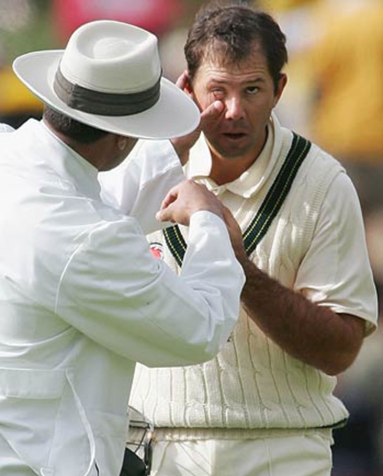 Umpire Aleem Dar sees to something in Ricky Ponting's eye, Australia v West Indies, 3rd Test, Adelaide, 2nd day, November 26, 2005