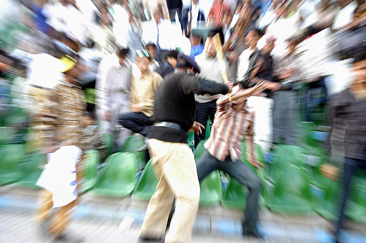 A Pakistani policeman beats a cricket fan, Pakistan v England, 3rd Lahore, November 30, 2005