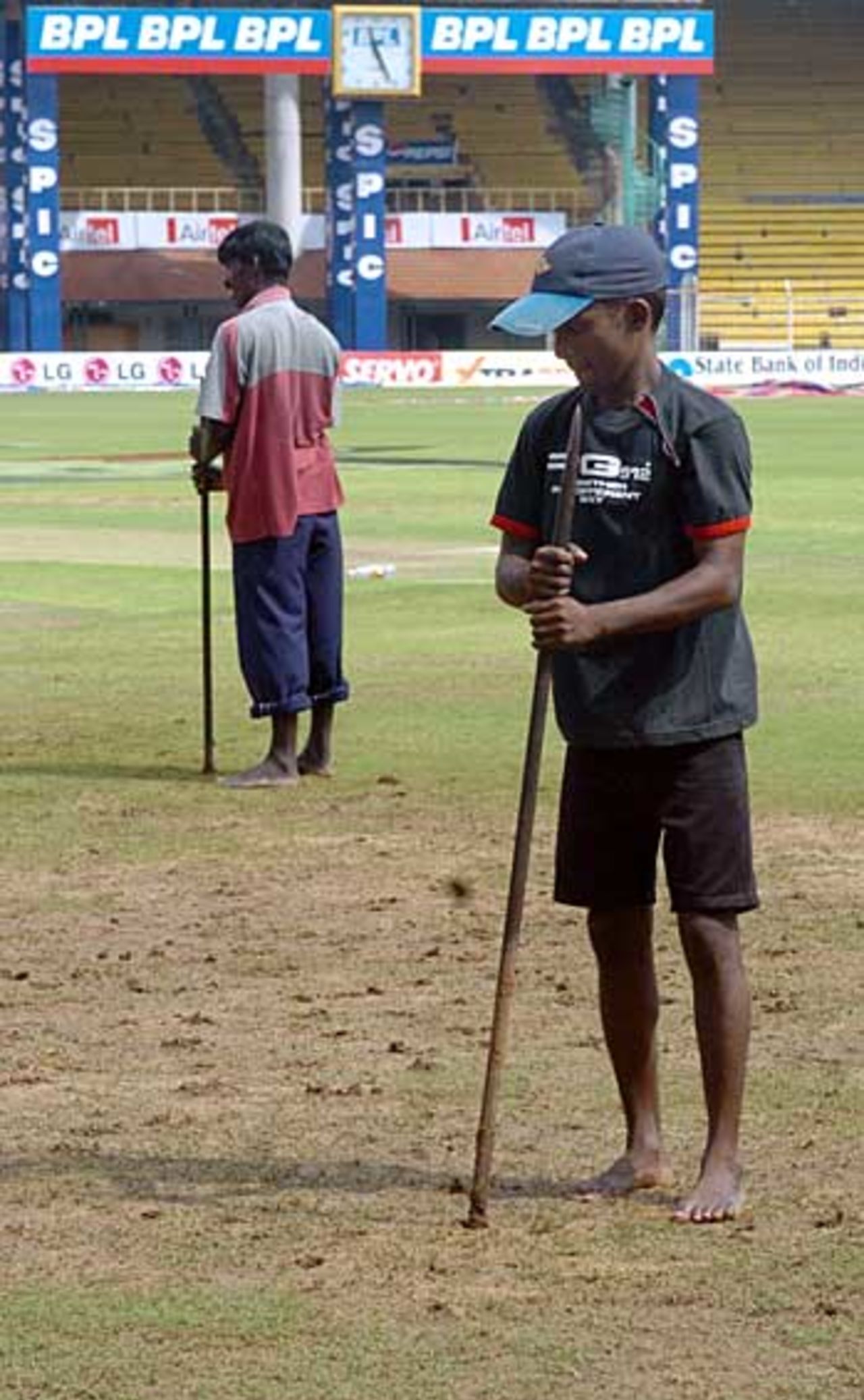 Groundsmen use shovels to drain the ground after another day was washed out, India v Sri Lanka, 1st Test, Chennai, December 4, 2005