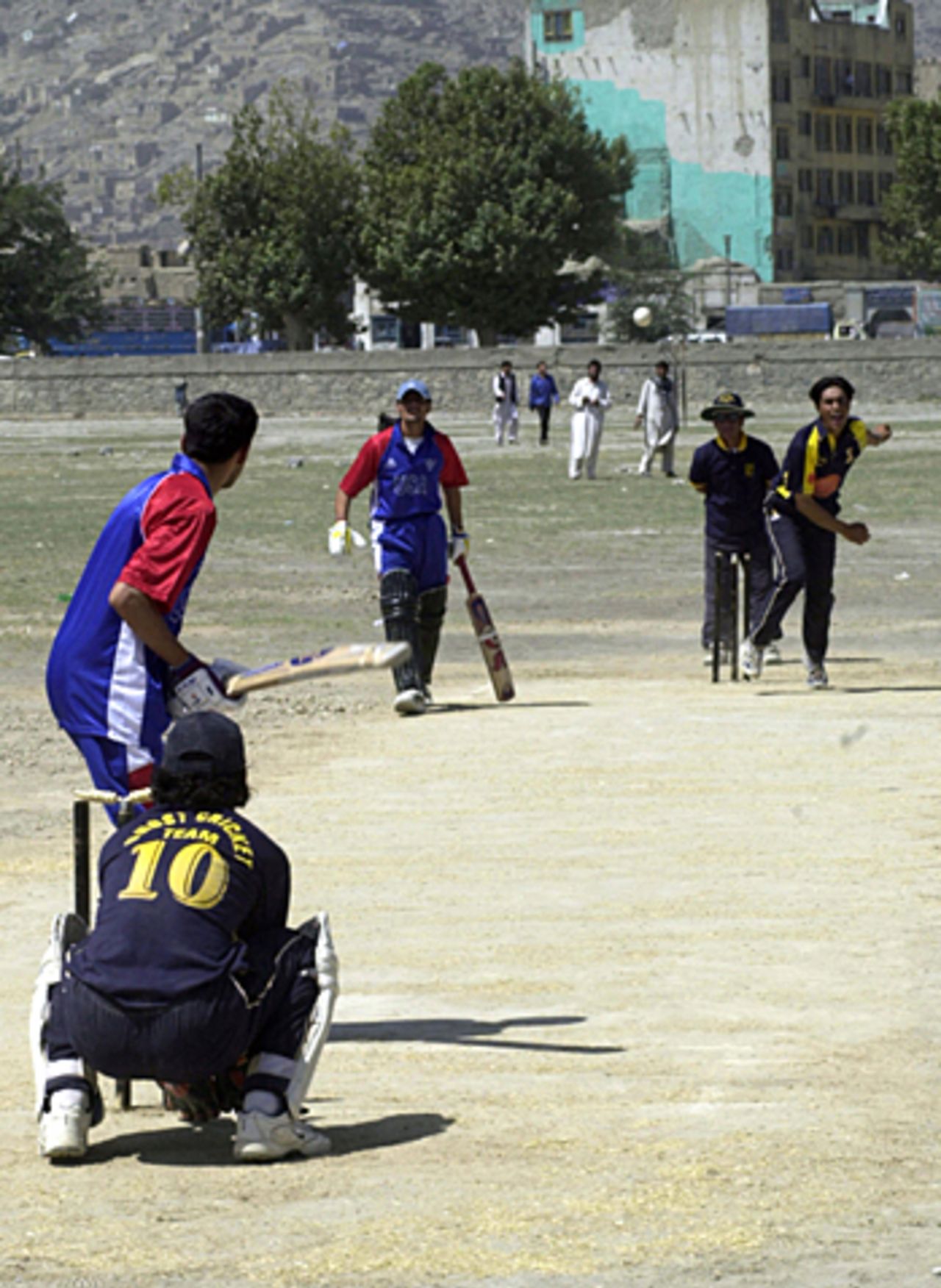 Afghan cricketers take part in a match on a ground in front of Kabul's Stadium, Afghanistan, August 9, 2005