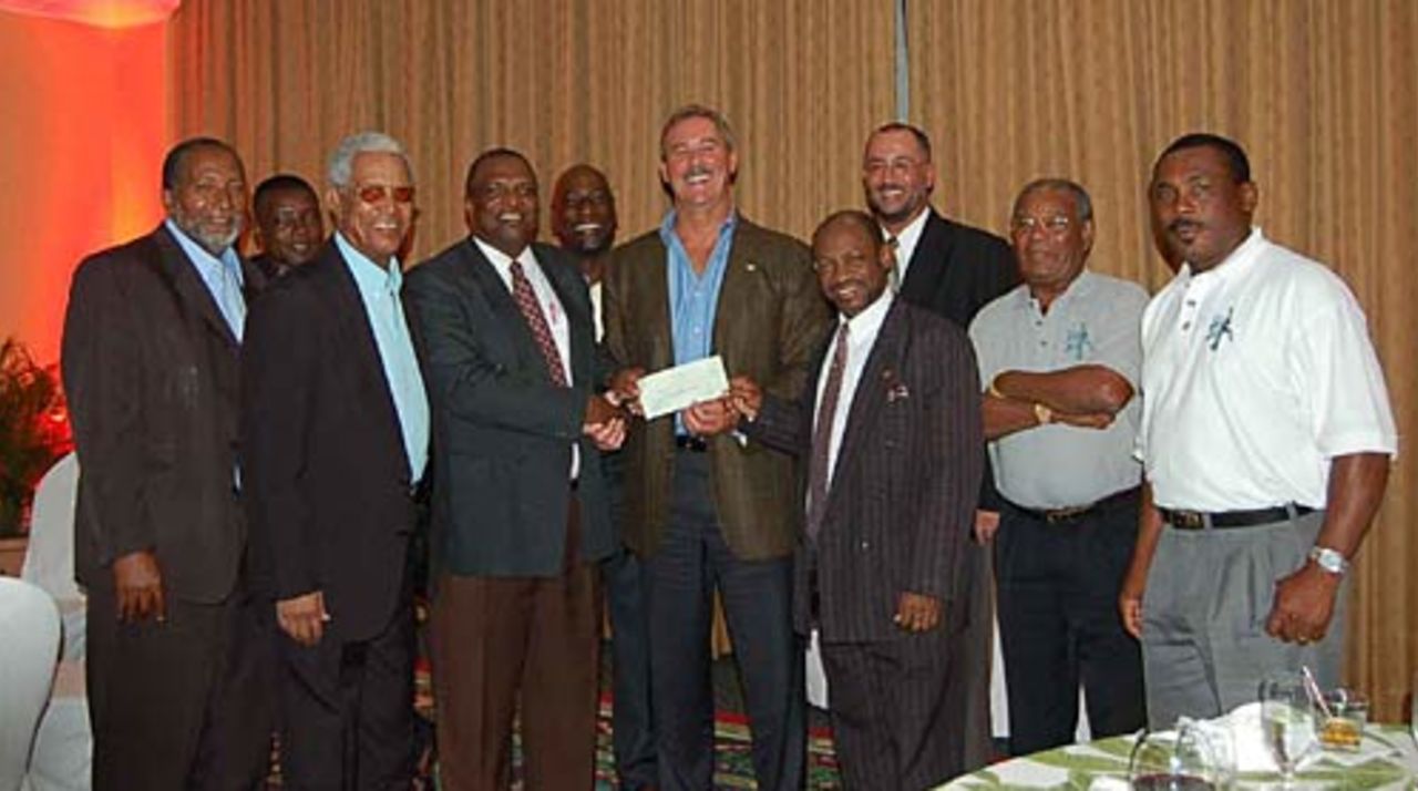 Allen Stanford presents Denzil Douglas, the PM of St Kitts and Nevis, with a cheque for a new cricket pitch, December 15, 2005