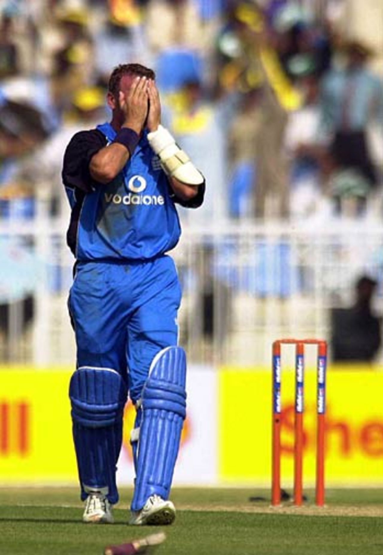 30 Oct 2000: Alec Stewart of England covers his eyes as Tear Gas enters the stadium during the 3rd Pakistan v England One Day International at the Pindi Stadium, Rawalpindi, Pakistan.