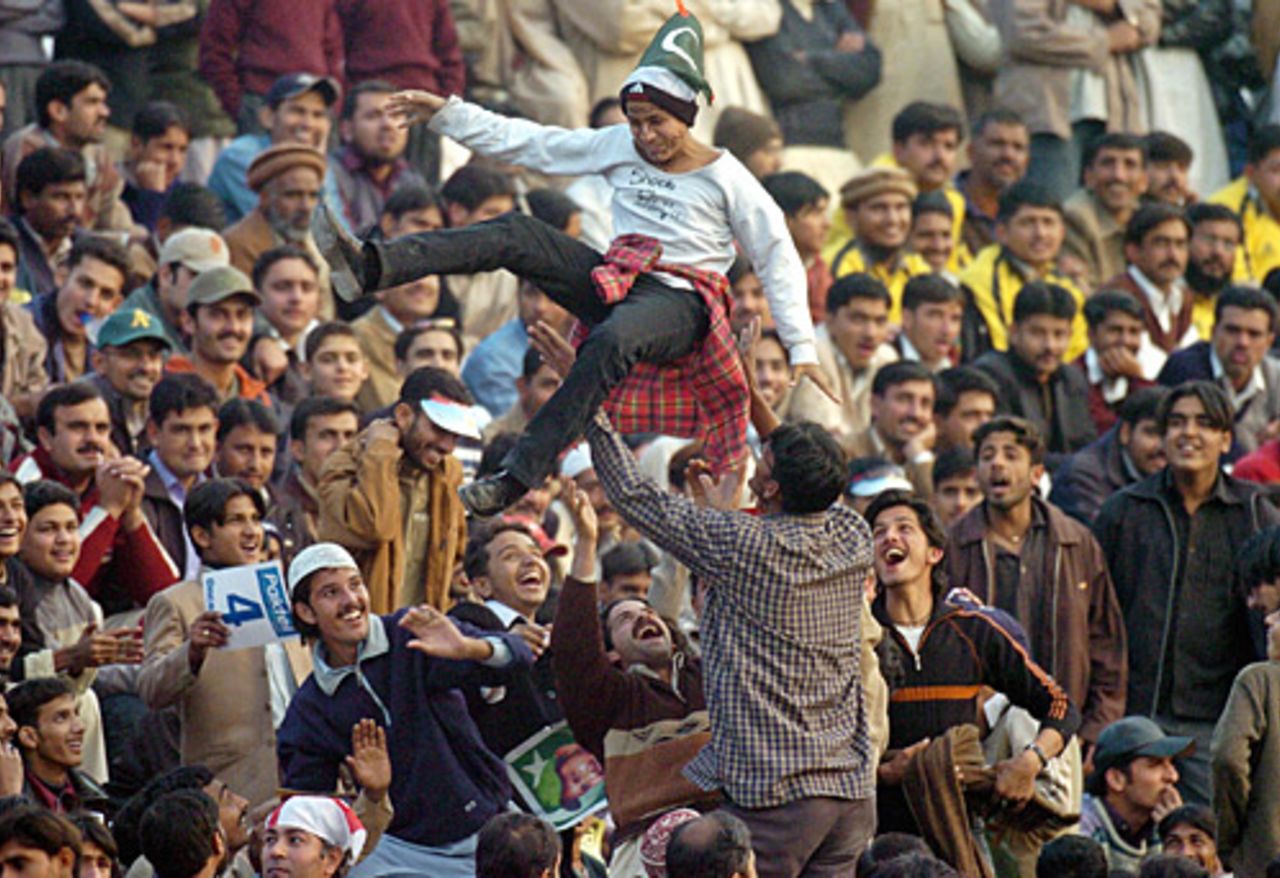 Pakistani fans lift a spectator, 5th ODI, Rawalpindi, December 21, 2005