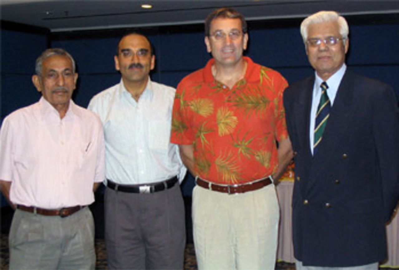 Hong Kong delegates Anoop Gidwani and Dr Hugh Tyrwhitt-Drake meet with international umpires K T Francis and Mahboob Shah at the ACC Umpiring Course held in Malaysia, December 2005