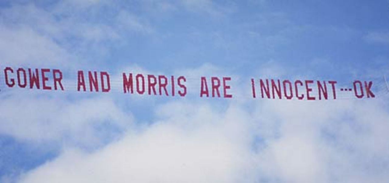 A banner proclaiming the innocence of David Gower and John Morris after the pair buzzed the ground at Cararra Oval, January 21, 1991