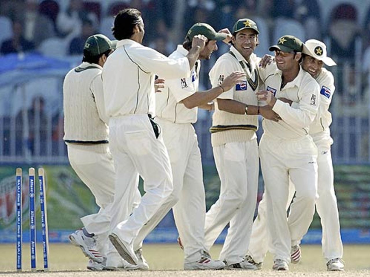 Imran Farhat is mobbed after a fine throw to run out Rahul Dravid, Pakistan v India, 2nd Test, 3rd day, Faisalabad, January 23, 2006