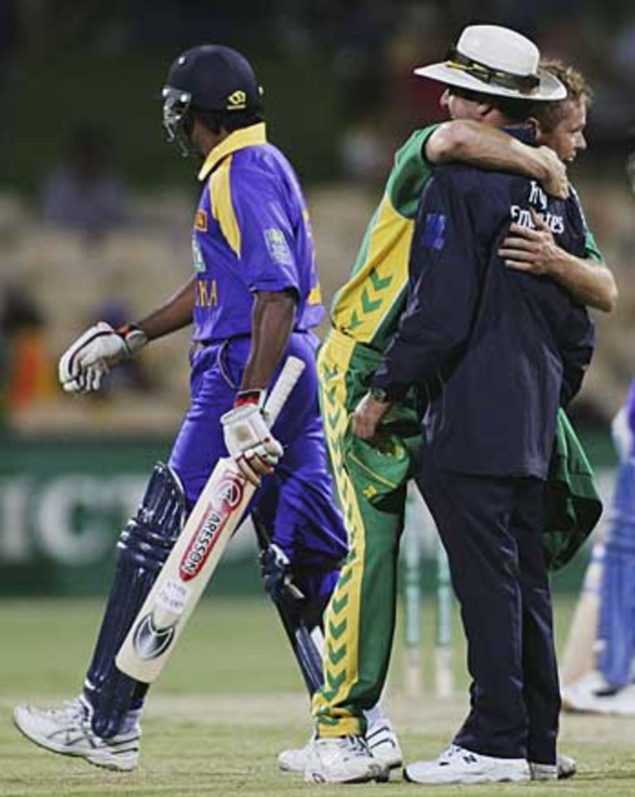 Shaun Pollock celebrates...by hugging umpire Aleem Dar, South Africa v Sri Lanka, 6th match, VB Series, Adelaide, January 24, 2006
